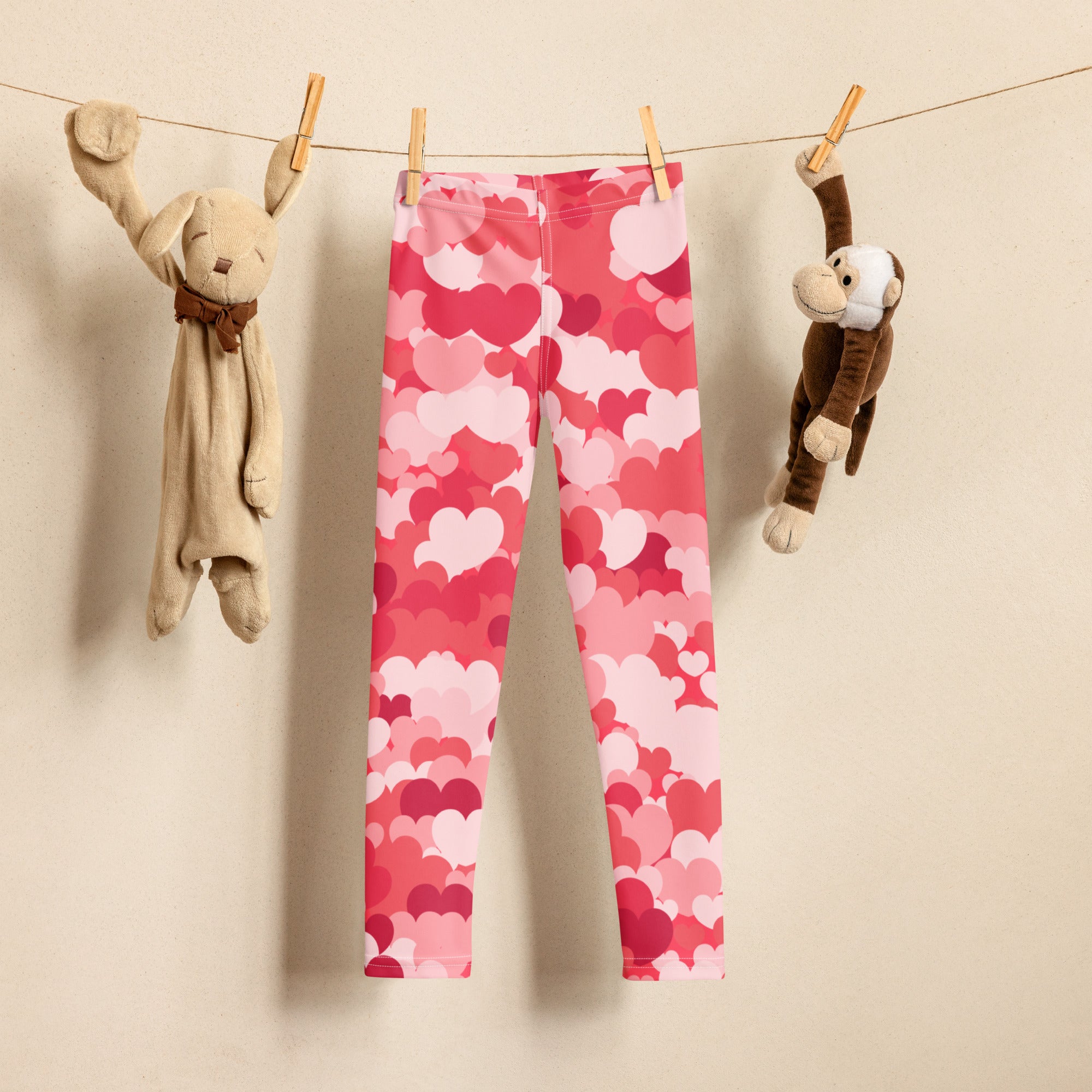 Girls pink heart cloud leggings buttery soft pink heart-patterned leggings hanging on a clothesline