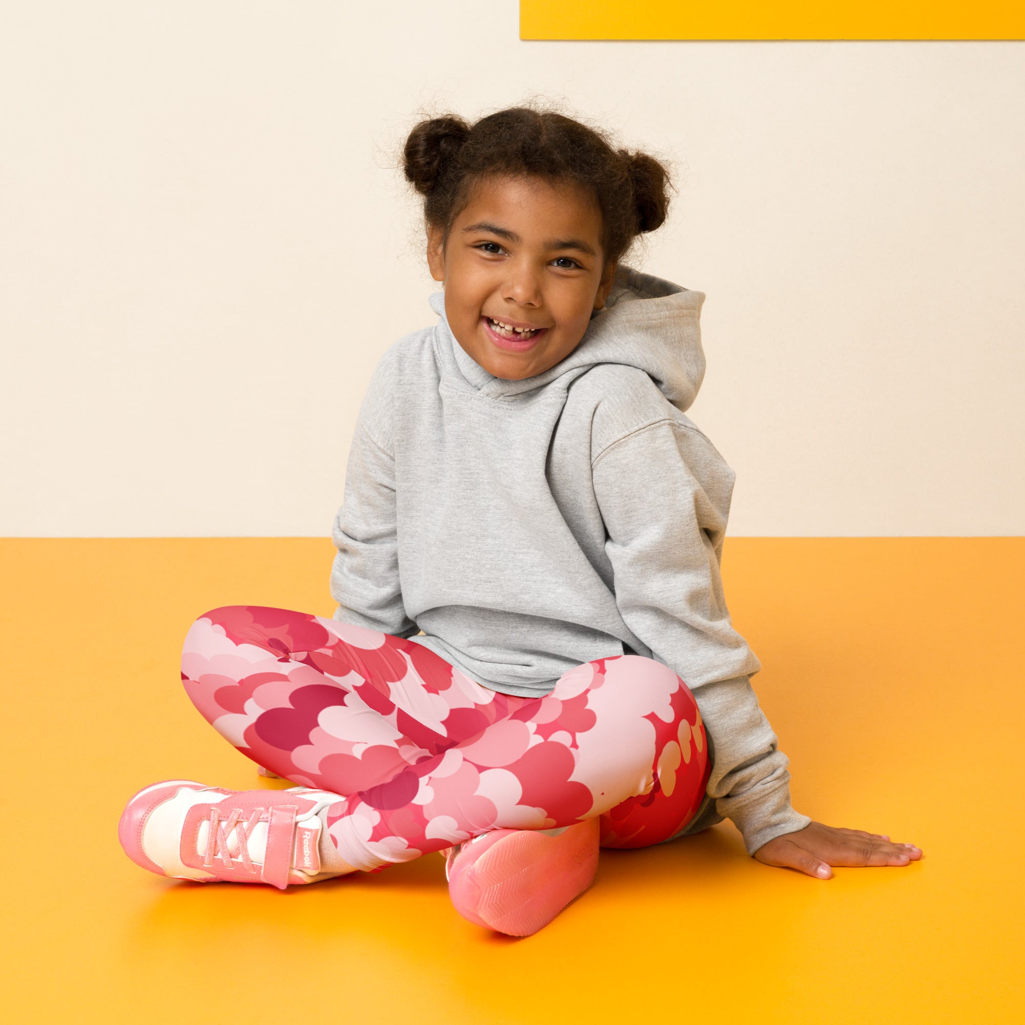 Girls pink heart cloud leggings showing the back side made of buttery soft fabric with a pink heart pattern