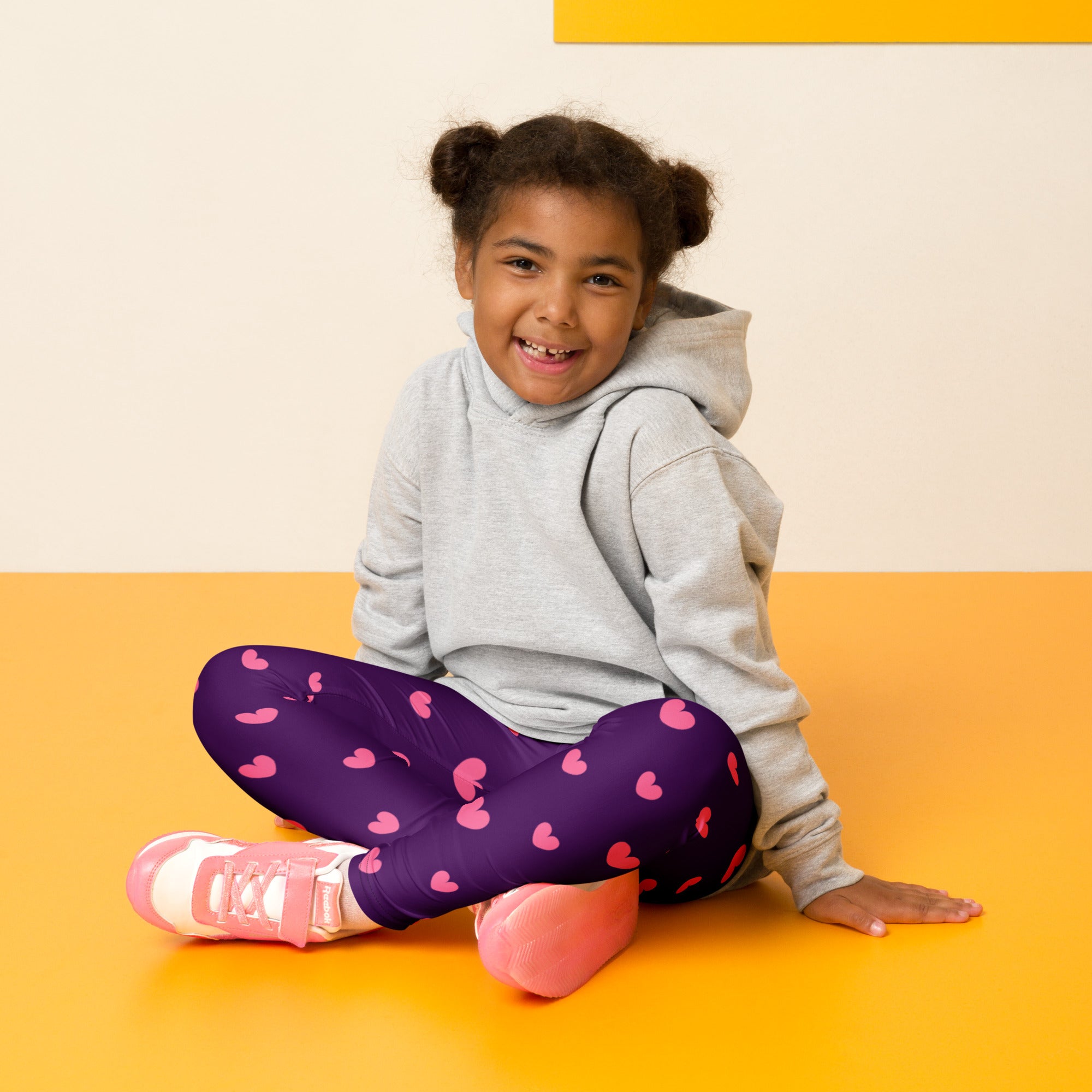 Girls purple buttery soft leggings with pink heart patterns perfect for comfortable everyday wear