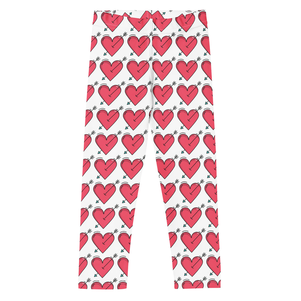 White girls buttery soft leggings with vibrant red hearts pierced by green tipped arrows for valentine’s day