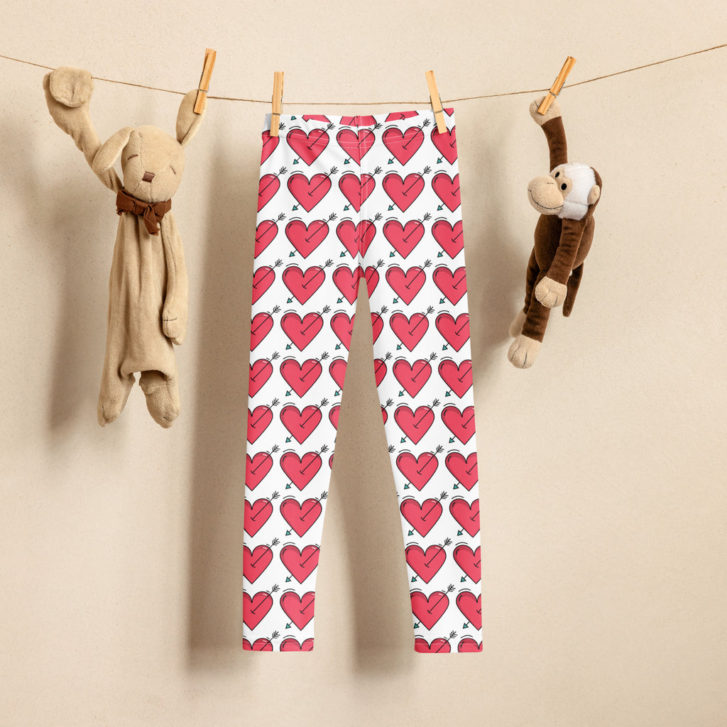 White girls buttery soft leggings with pink heart and small green arrow pattern for valentine’s day