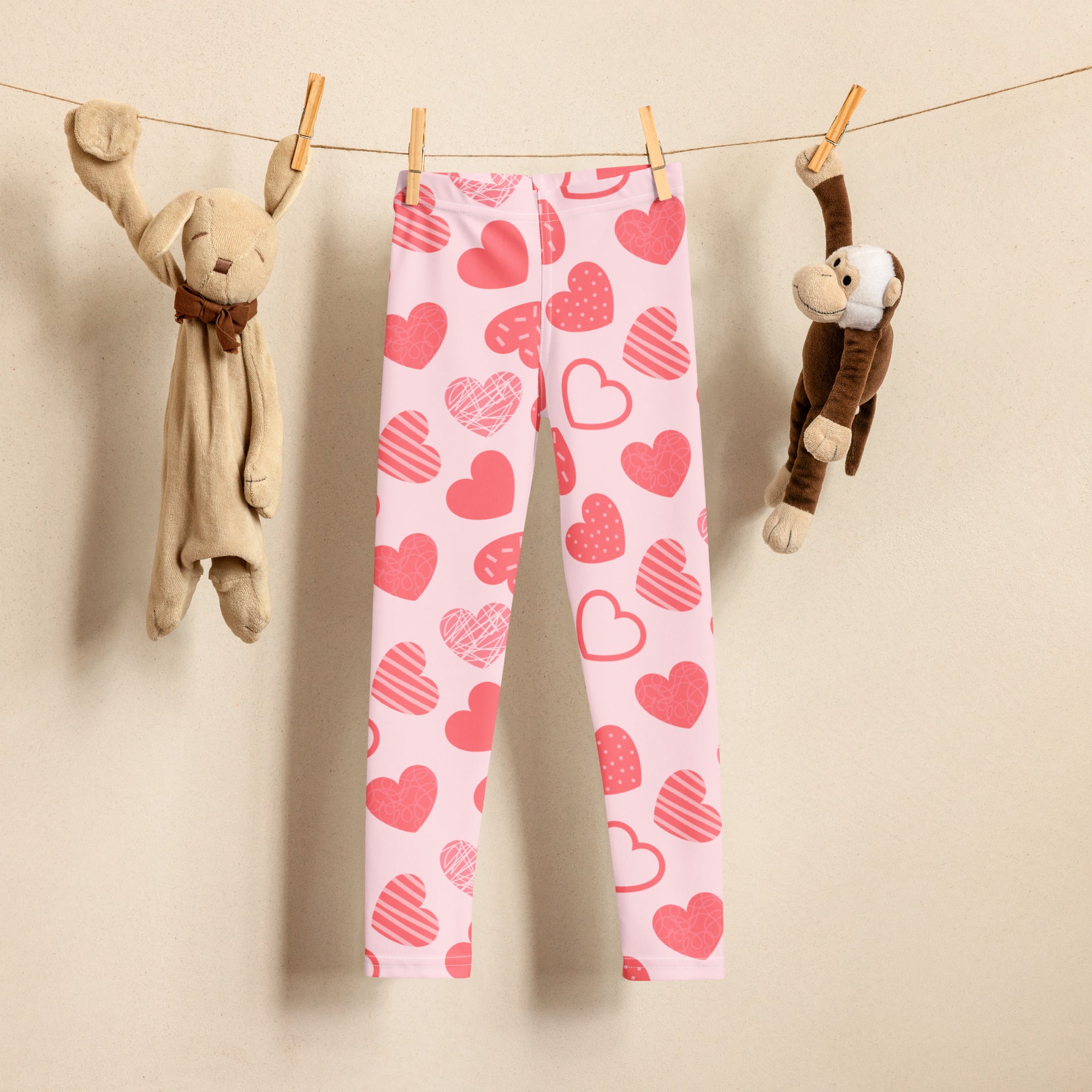Girls pink heart pattern leggings featuring solid and striped red hearts on buttery soft stretchy fabric