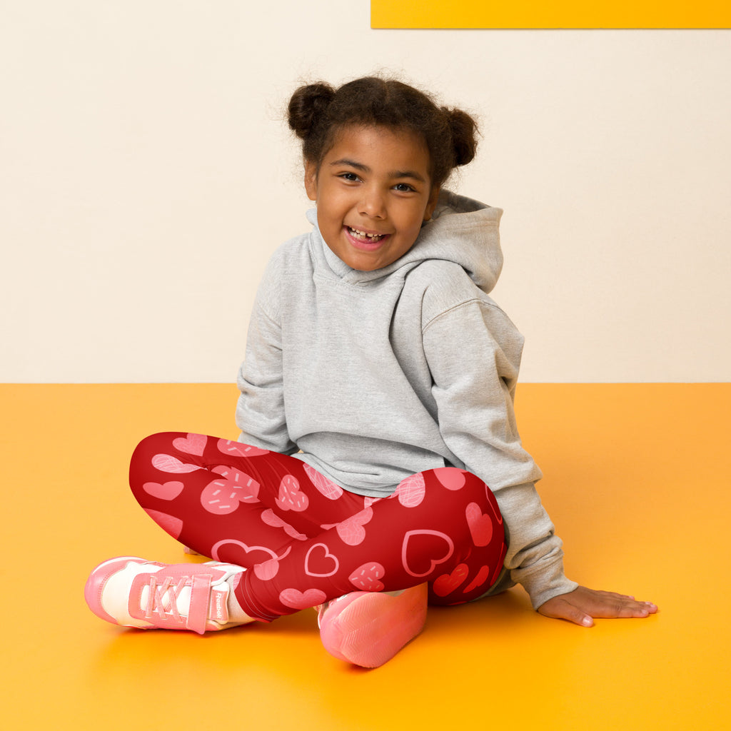 Girls red heart pattern leggings featuring pink hearts made from buttery soft fabric for comfortable wear