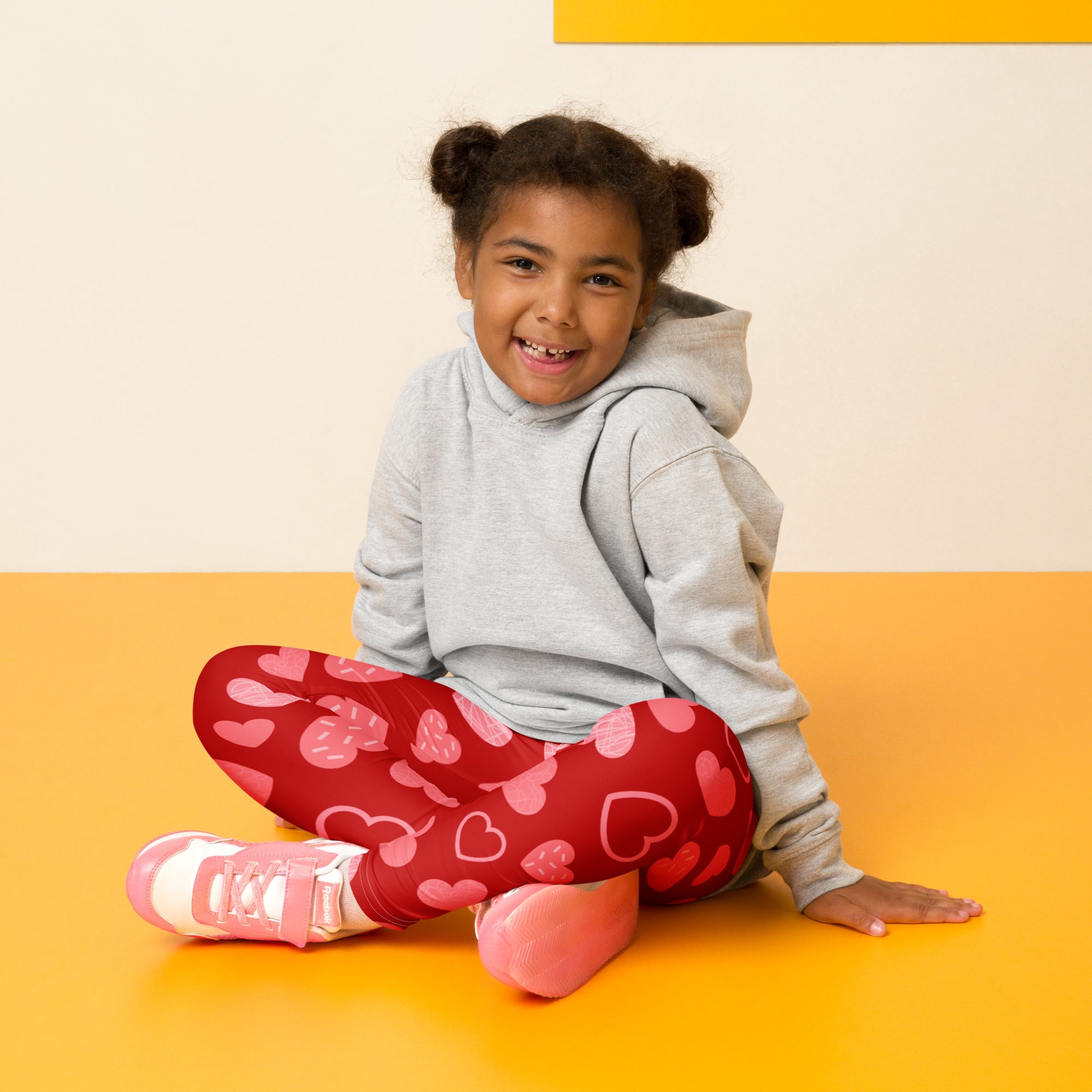 Girls red heart pattern leggings featuring pink hearts made from buttery soft fabric for comfortable wear