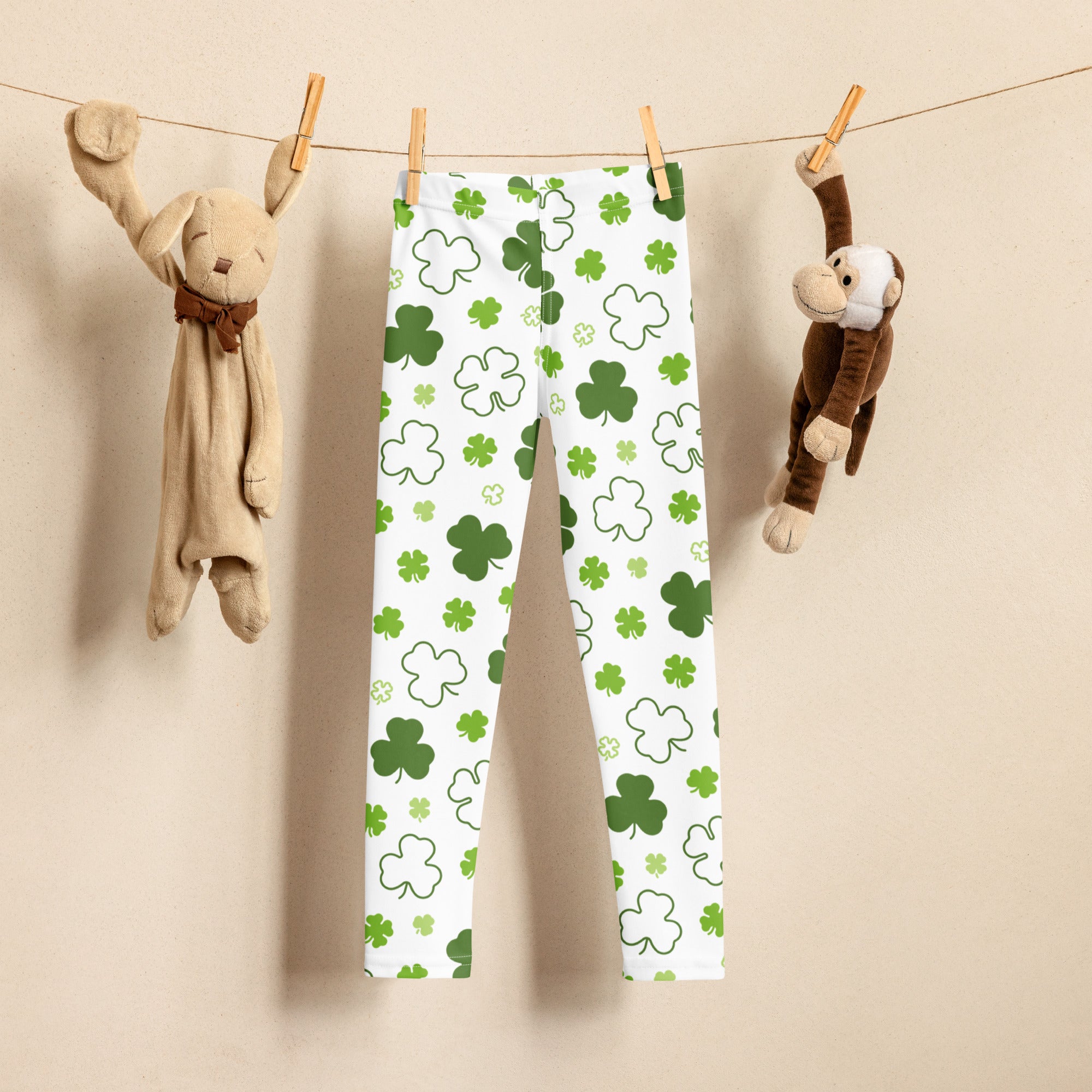 Girls white buttery soft leggings with playful green and white shamrock pattern perfect for festive wear