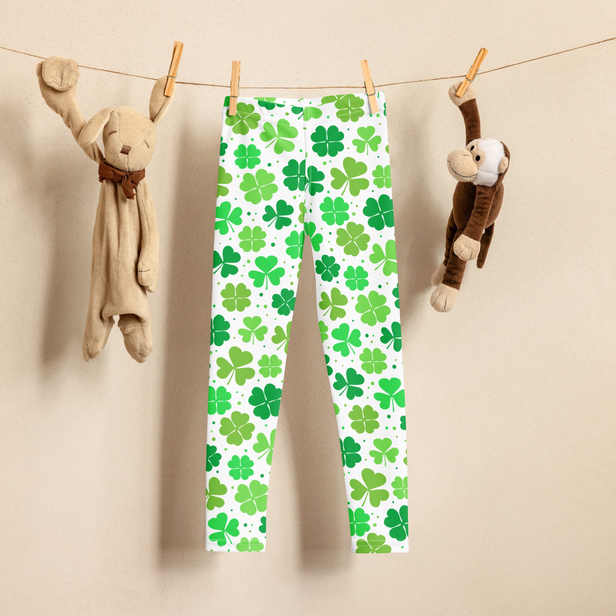 Girls lucky shamrock buttery soft white leggings with a vibrant pattern of green four leaf clovers