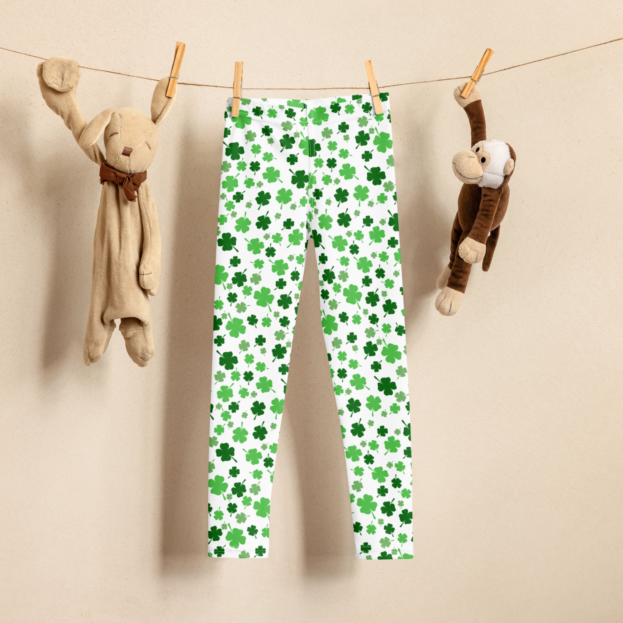 White girls buttery soft leggings with green shamrock print pattern in varying shades