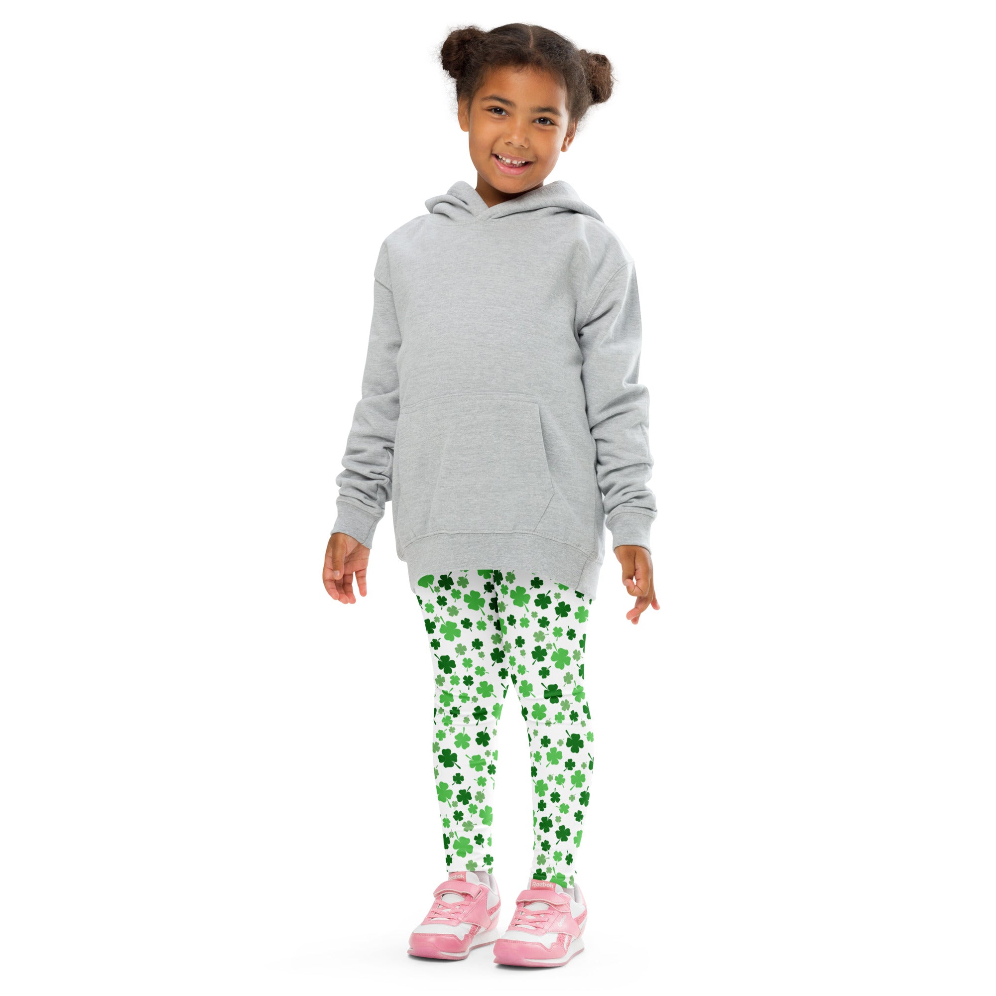 Gray hooded sweatshirt with front pocket and long sleeves worn over green shamrock print buttery soft leggings for girls