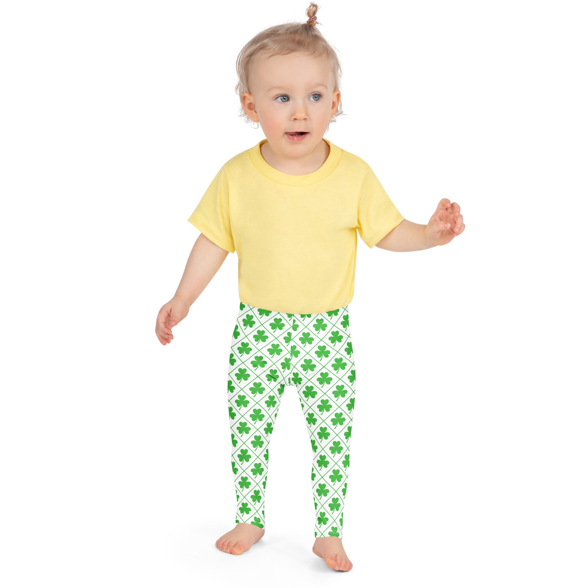 Girls shamrock grid buttery soft leggings in bright green with shamrock pattern worn by a child