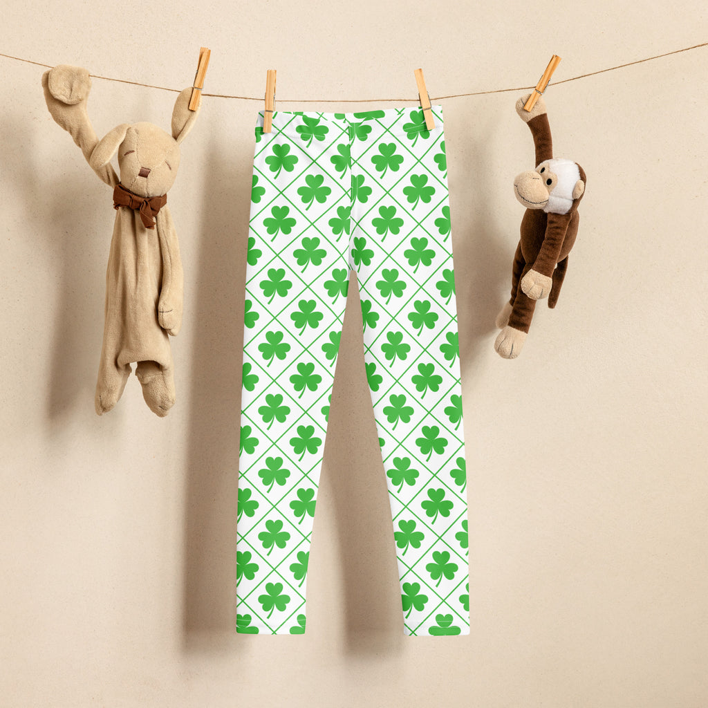Girls shamrock grid buttery soft leggings in green with shamrock pattern and diamond design hanging on a clothesline