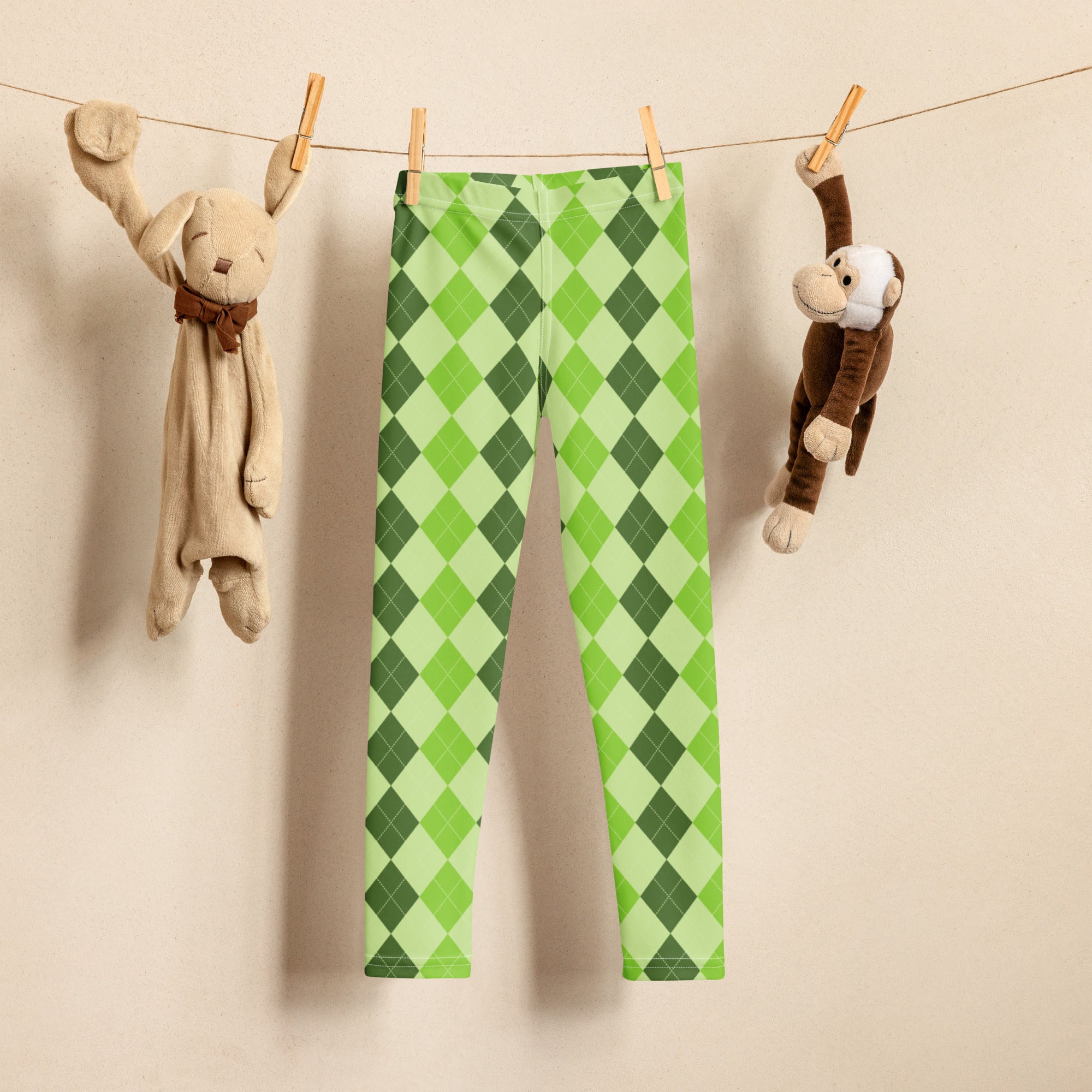 Girls light green argyle buttery soft leggings hanging on a clothesline showing their soft fabric texture
