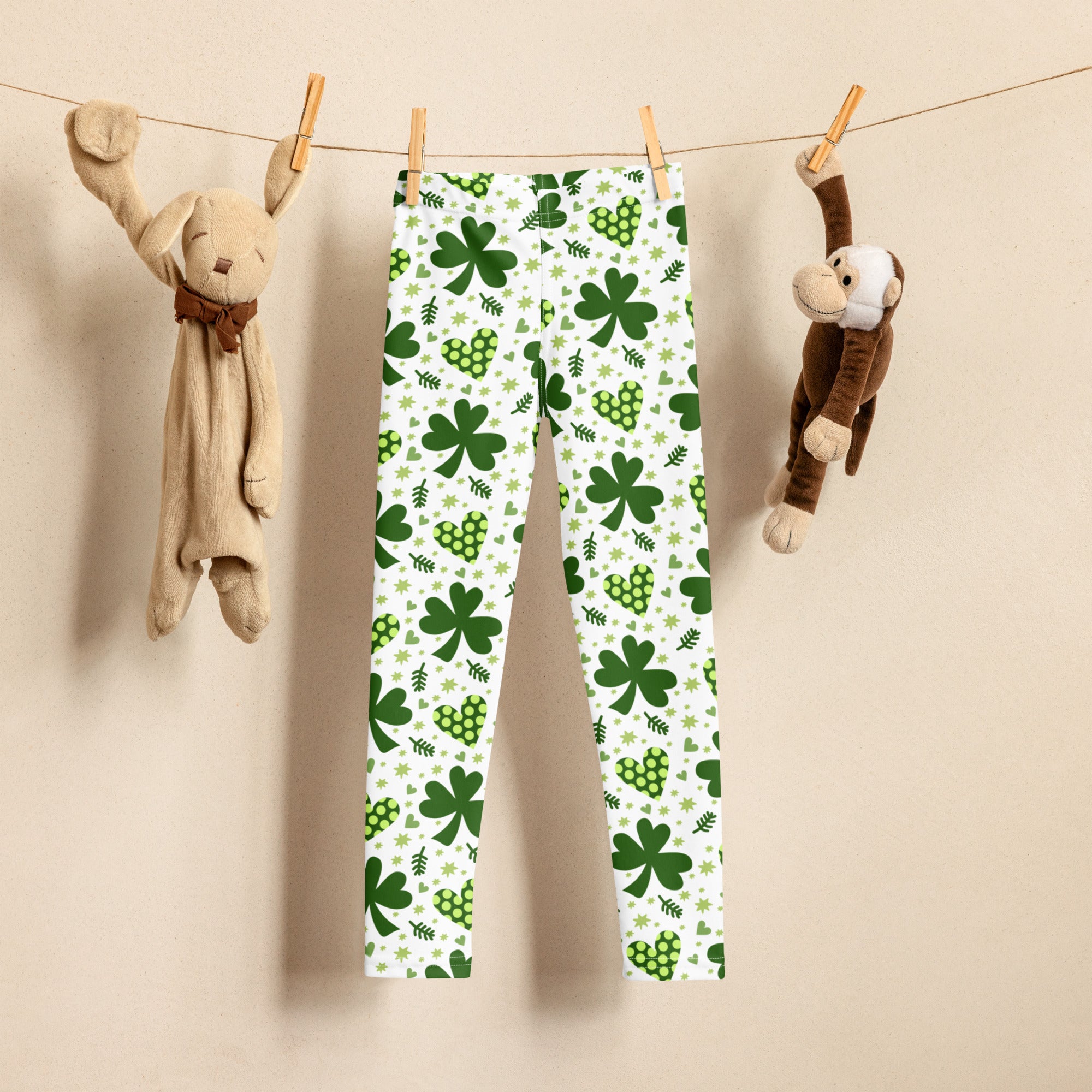 Girls buttery soft white leggings with vibrant green shamrock and heart pattern perfect for festive wear