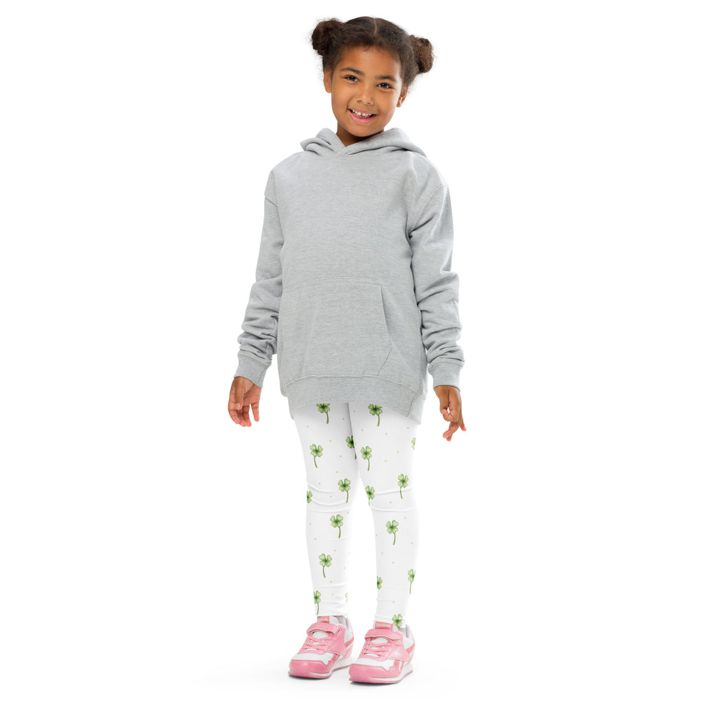 A child models light gray long sleeve hooded sweatshirt with front pocket and white buttery soft leggings with green shamrocks