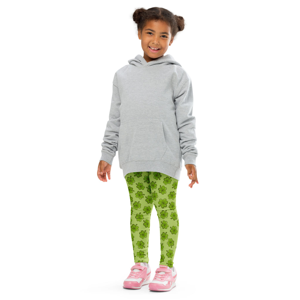 A child wearing girls lime green shamrock buttery soft leggings paired with a light gray hooded sweatshirt