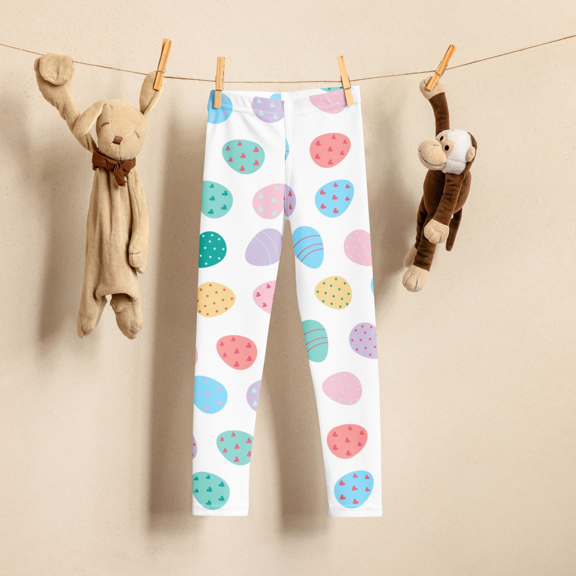 White girls leggings with colorful pastel easter egg patterns in blue pink green and yellow buttery soft fabric