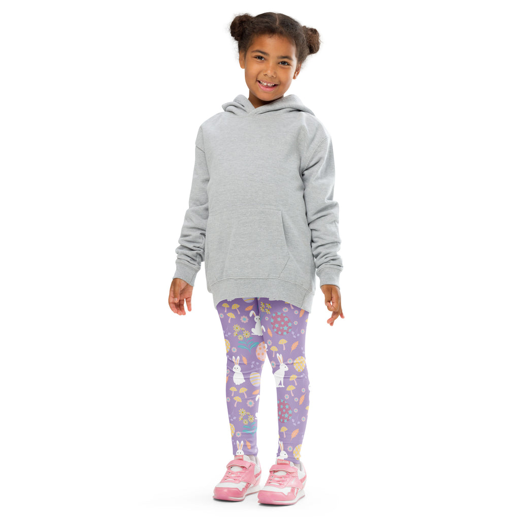 A child wearing girls purple Easter bunny buttery soft leggings with white bunny and Easter egg patterns and a gray hoodie