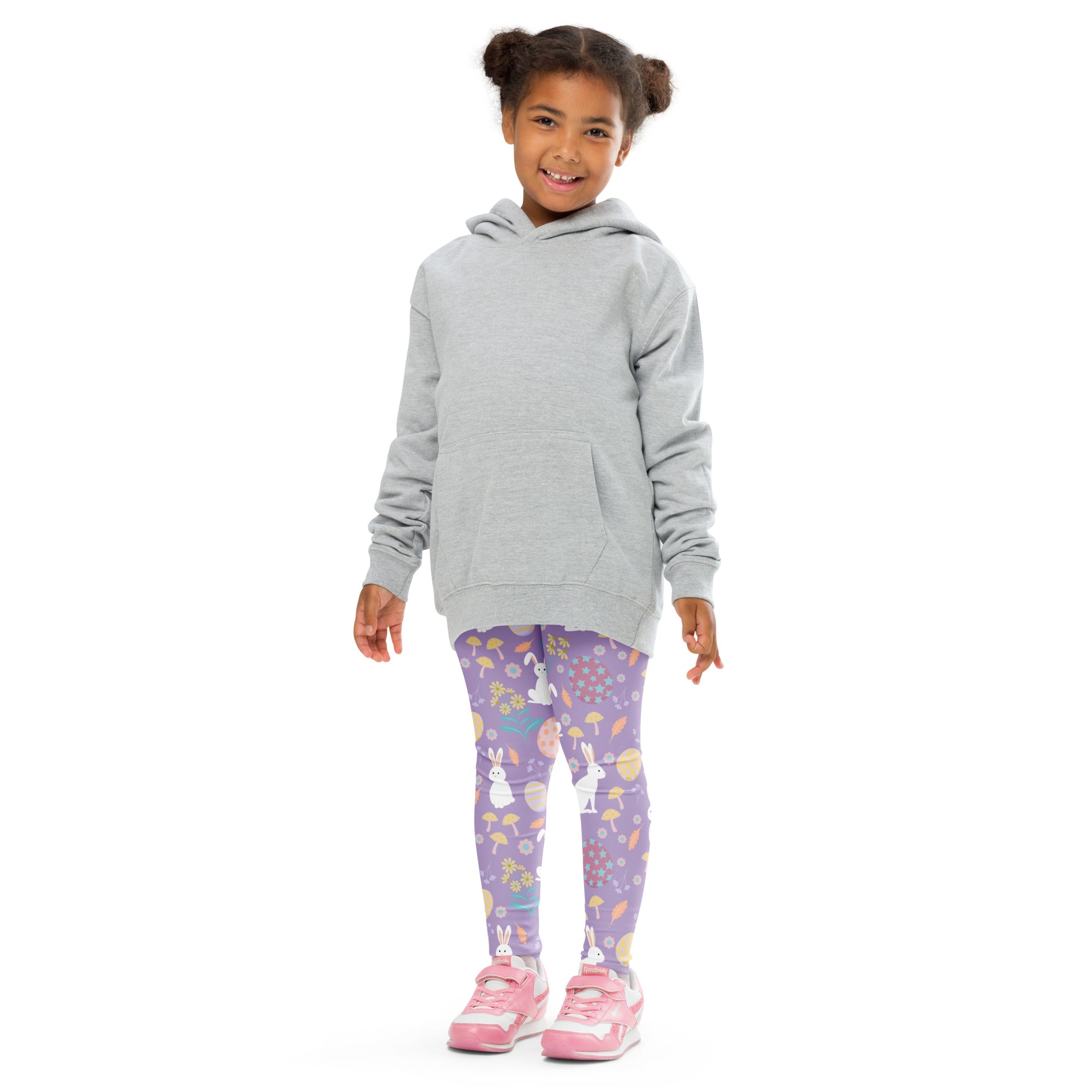 A child wearing girls purple Easter bunny buttery soft leggings with white bunny and Easter egg patterns and a gray hoodie