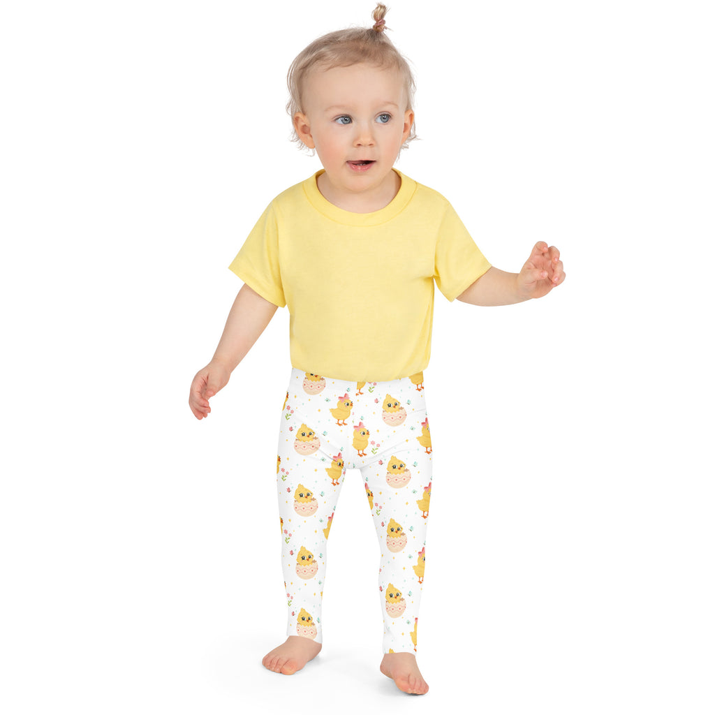 Girls easter chick buttery soft white leggings with yellow chick pattern worn by toddler front side