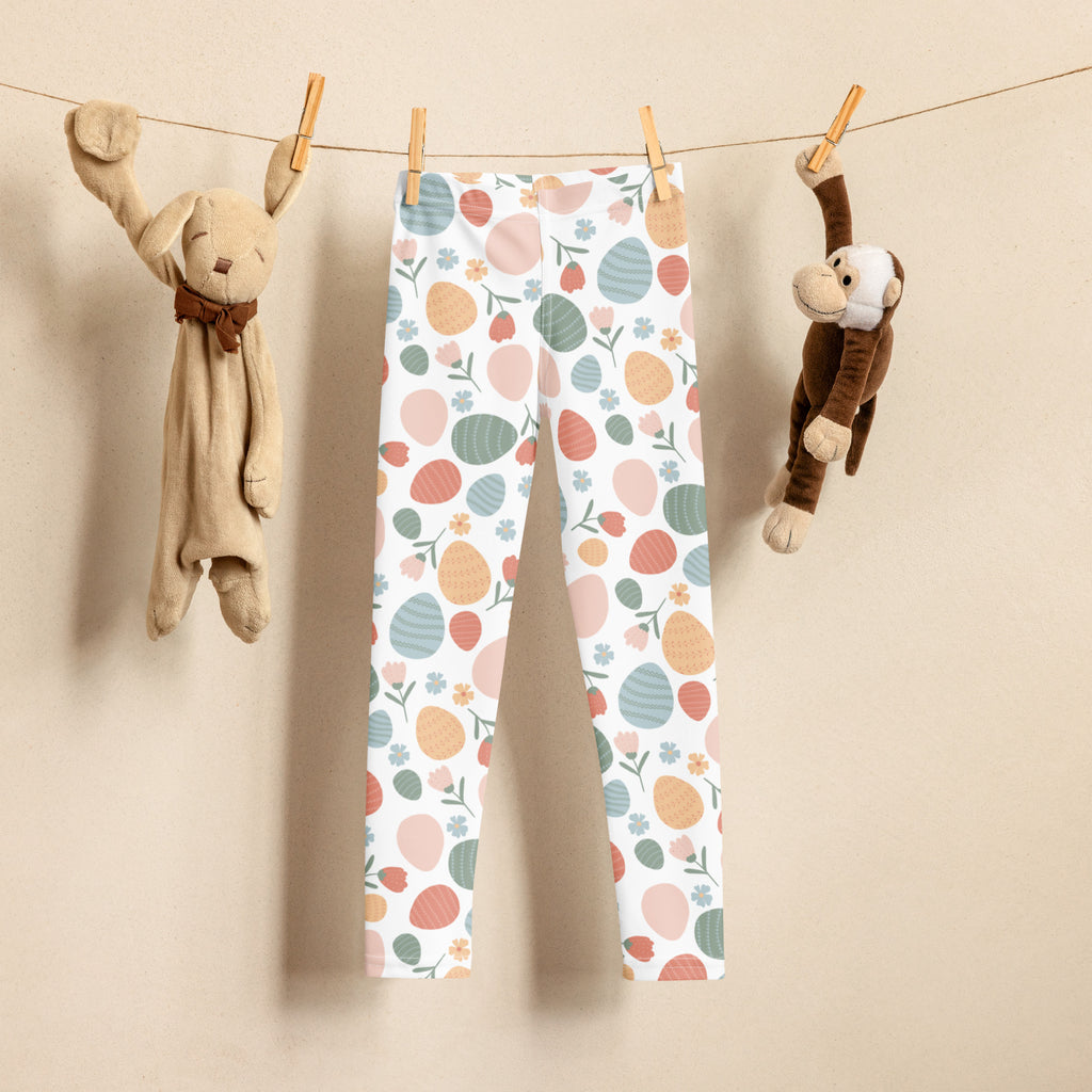 Girls floral easter egg buttery soft leggings in pastel colors with playful egg and floral patterns hanging on a clothesline