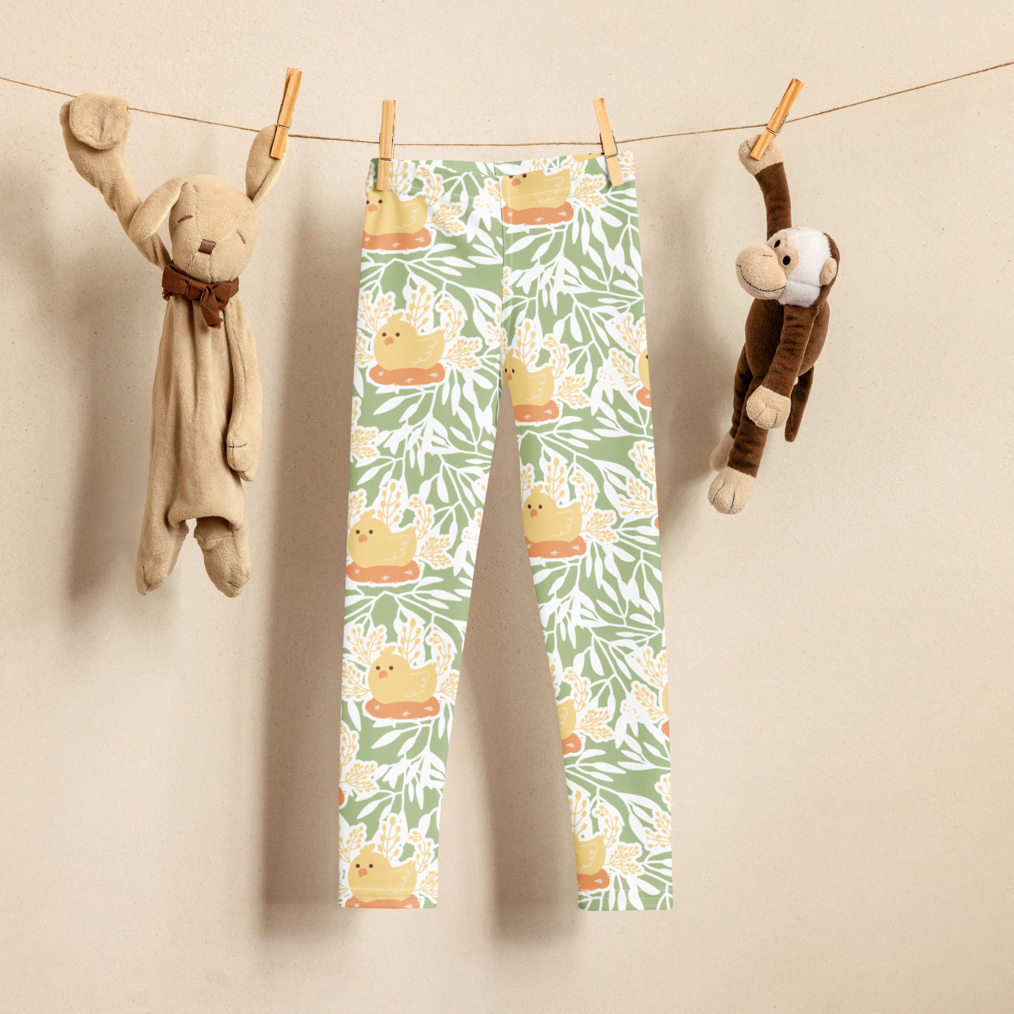 Girls sage green floral buttery soft leggings with yellow ducklings on orange platforms and leafy foliage pattern