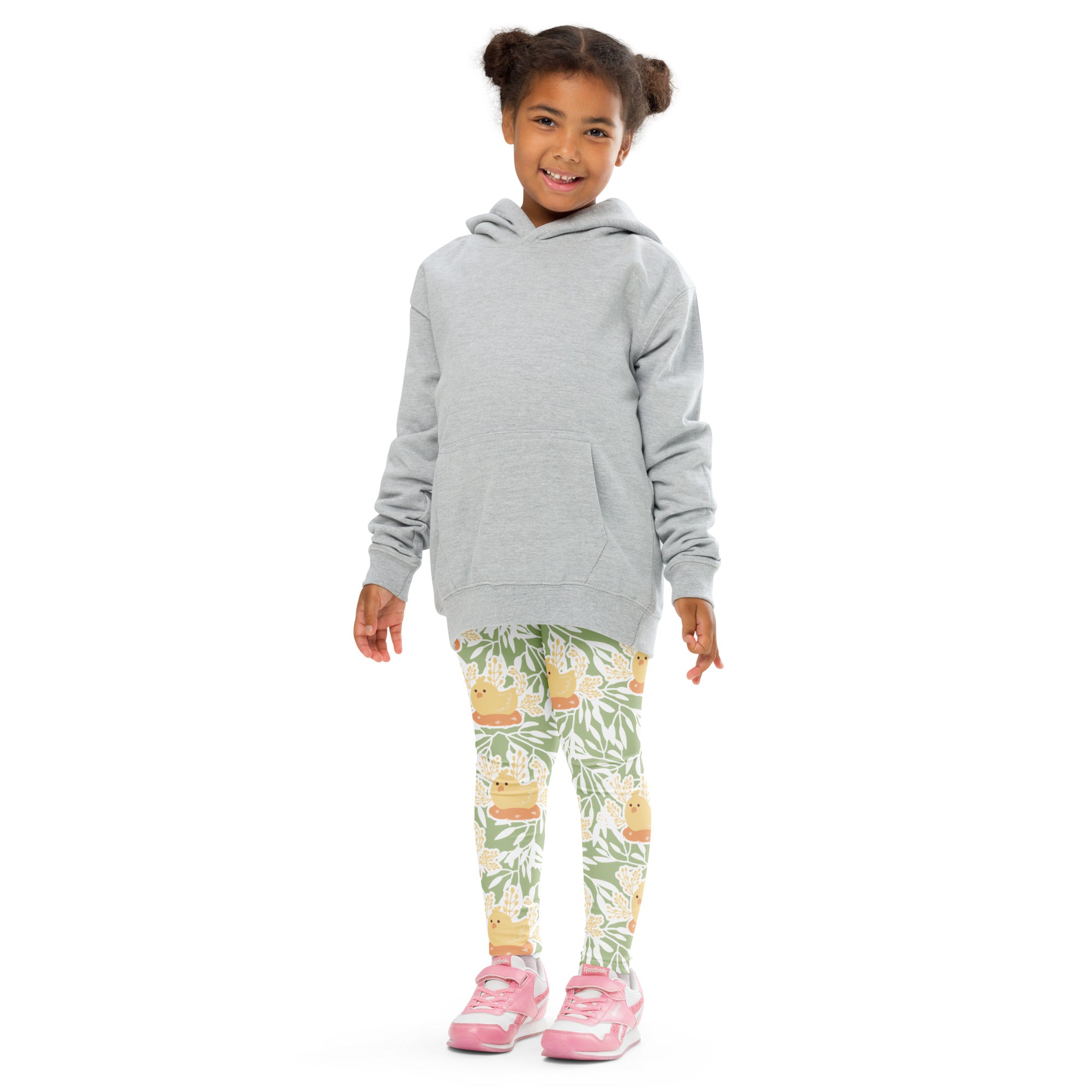 A child wearing girls sage green floral buttery soft leggings with cartoon duck designs paired with a gray hoodie