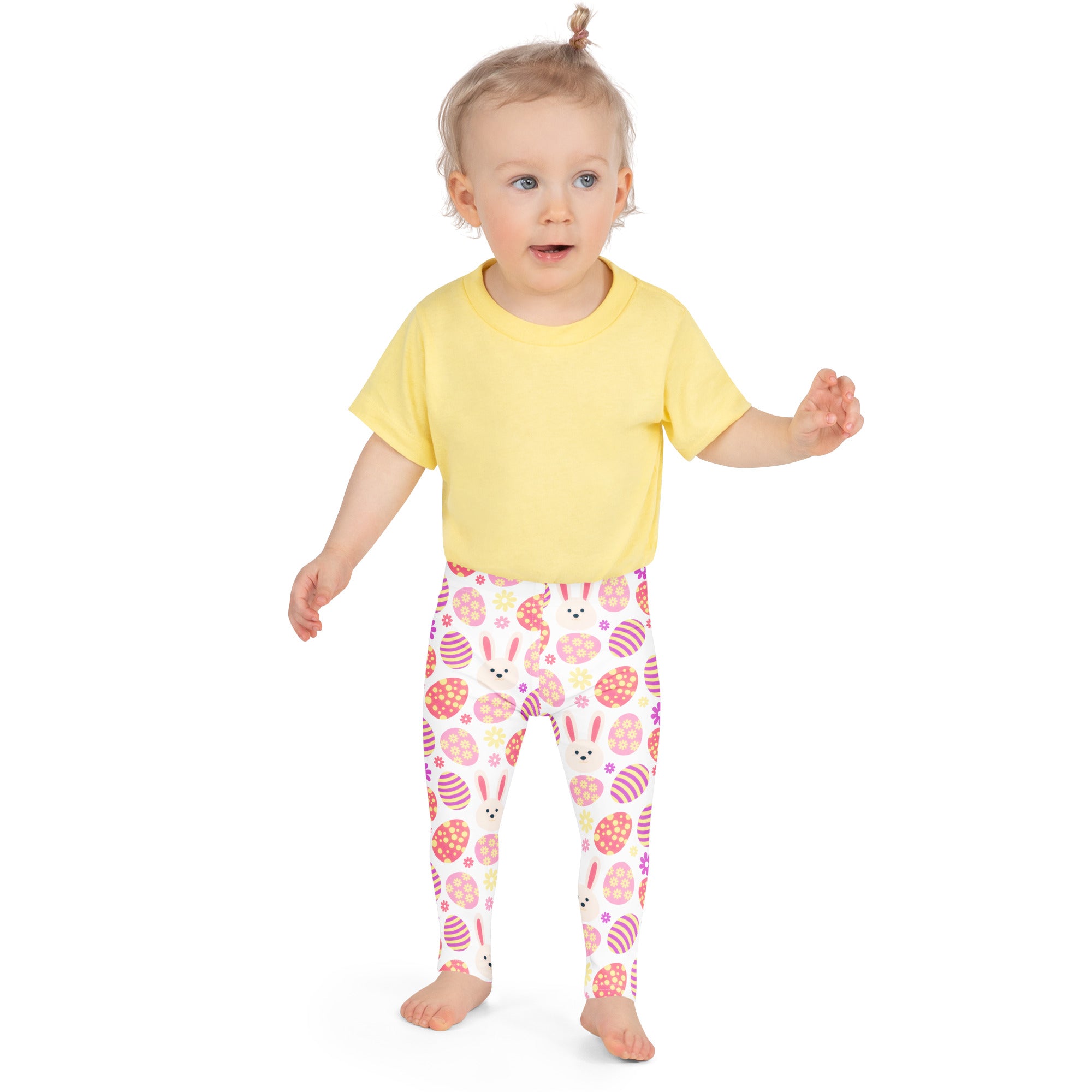 A child wearing girls pink bunny Easter egg buttery soft white leggings with colorful Easter patterns and a yellow shirt