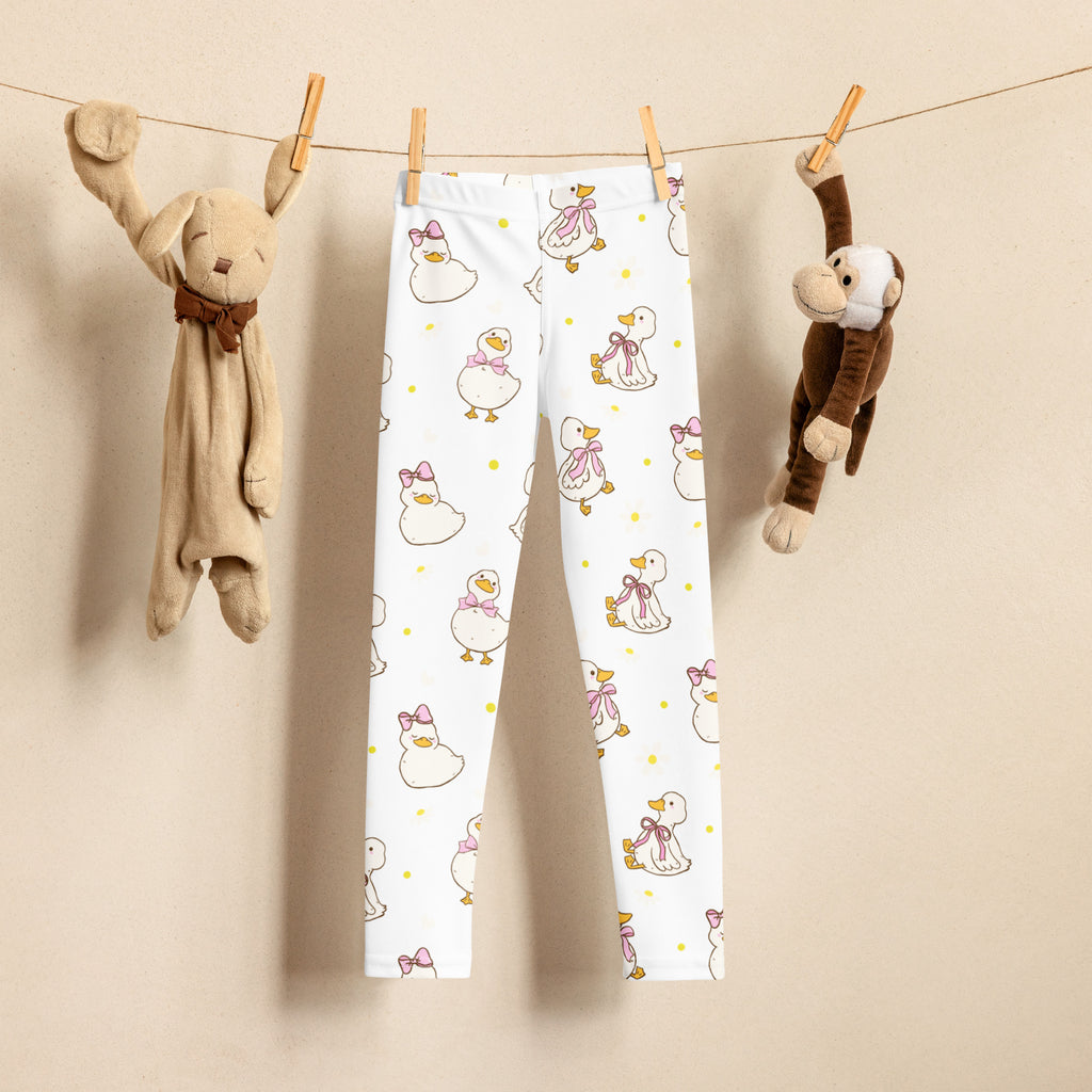 White girls easter duck buttery soft leggings with playful cartoon ducks wearing pink bows and yellow polka dots