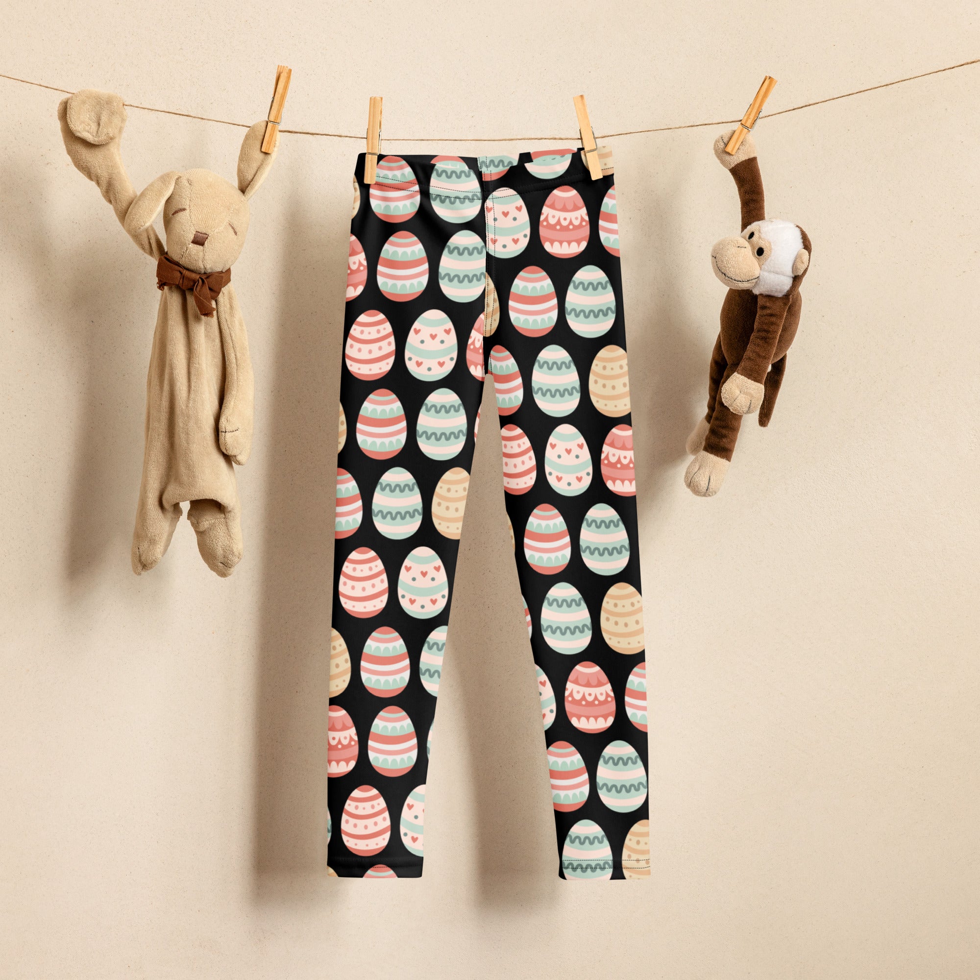 Girls black buttery soft leggings with pastel easter egg pattern featuring stripes hearts and wavy lines