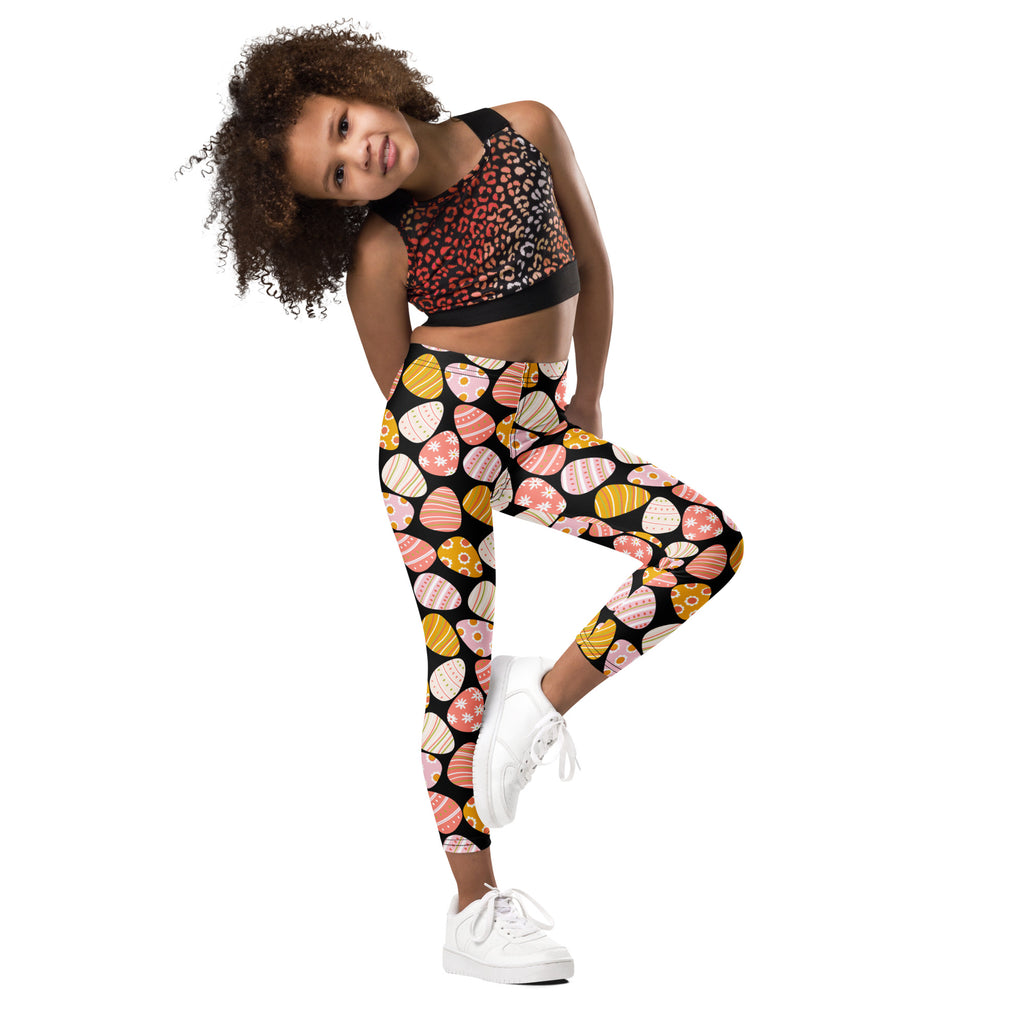 Girls bold Easter egg buttery soft leggings in black with vibrant pastel eggs and floral decorative stripes pattern