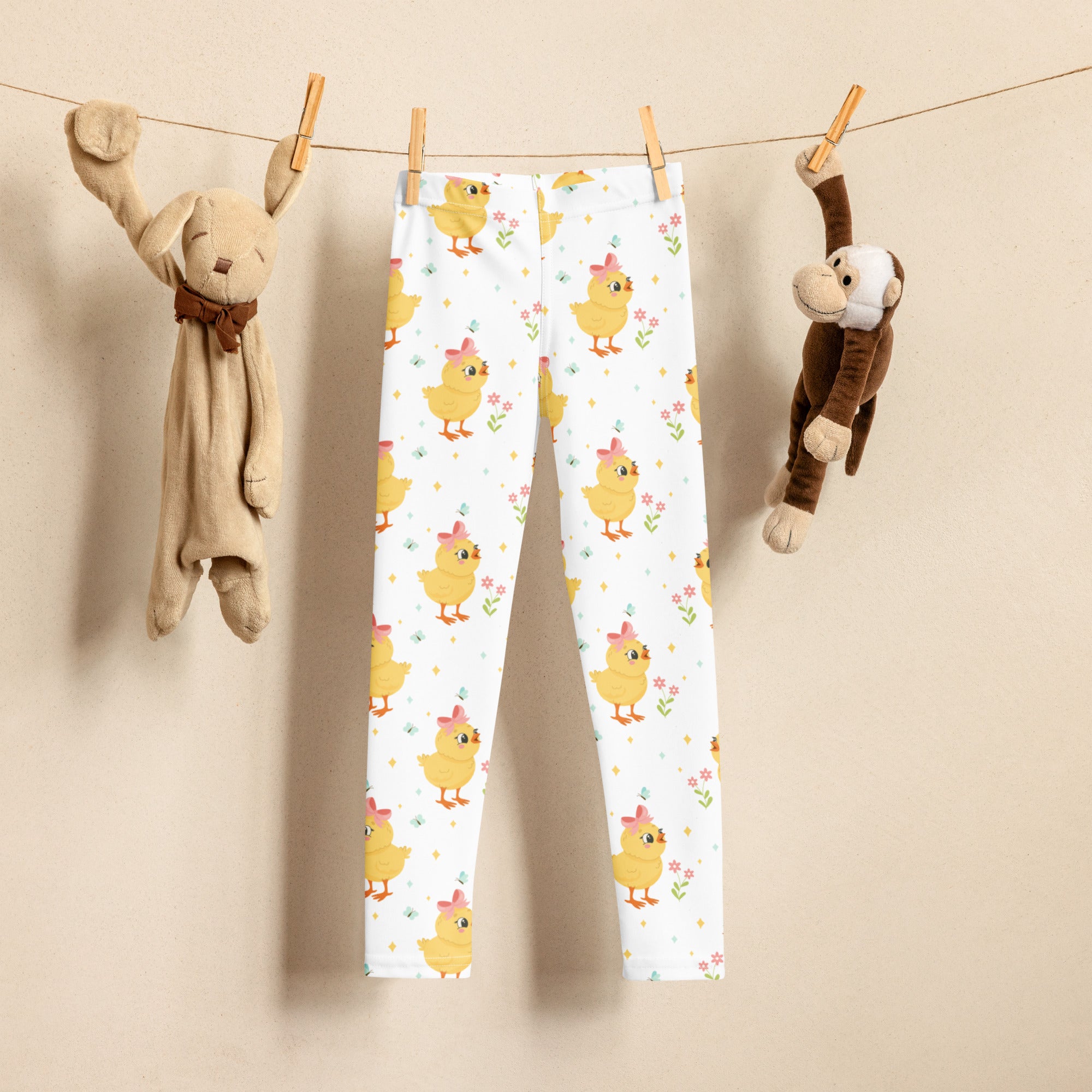 White girls cute chick Easter buttery soft leggings with yellow chicks wearing pink bows and small flowers pattern