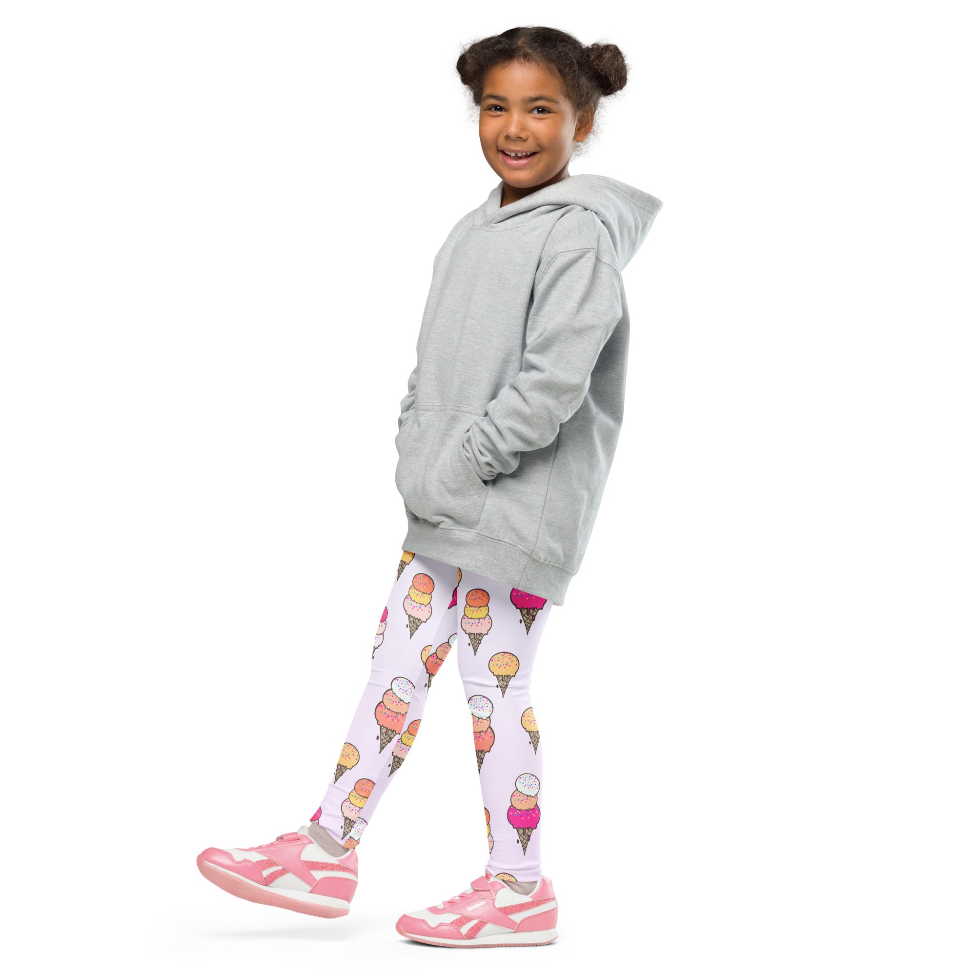 Smiling girl in grey hoodie and white kids leggings with colorful ice cream cone print