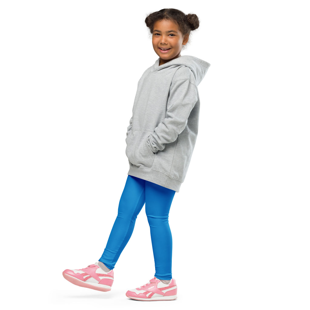 A child wearing kids buttery soft blue leggings made of soft fabric paired with a light gray hooded sweatshirt and sneakers