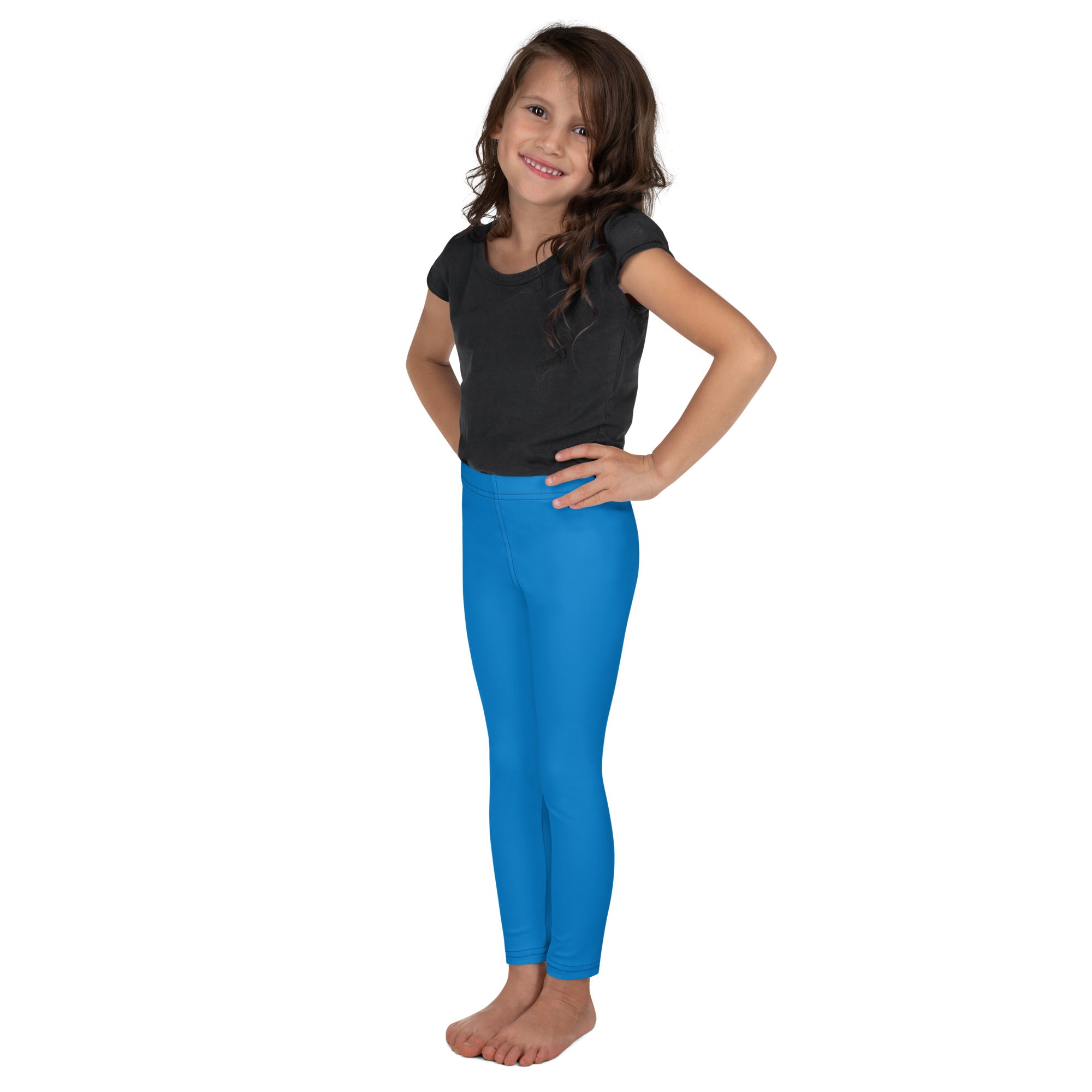 Bright blue kids buttery soft leggings worn by a young girl with a form-fitting comfortable design