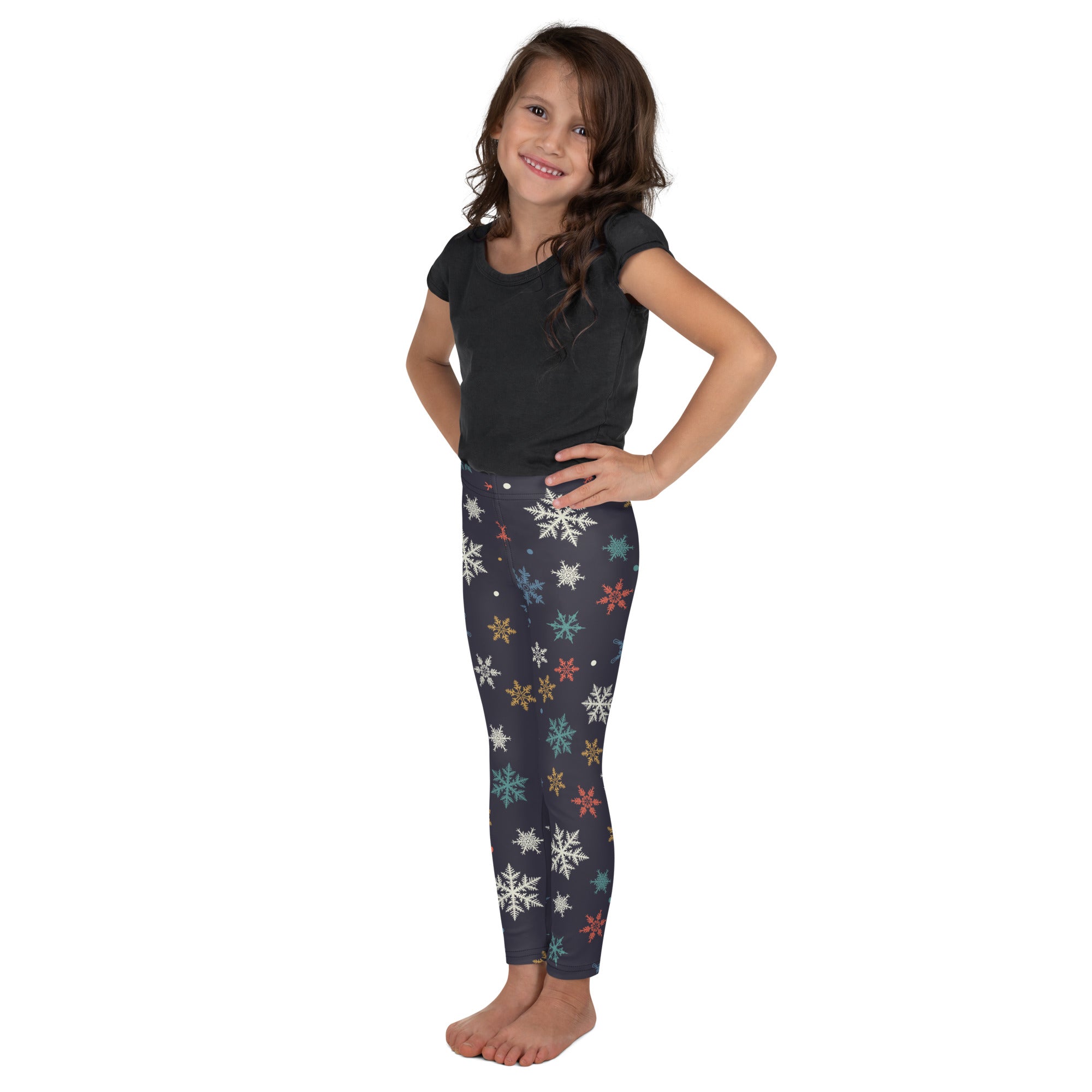 Dark gray festive kids Christmas leggings with colorful white teal red and gold snowflake pattern