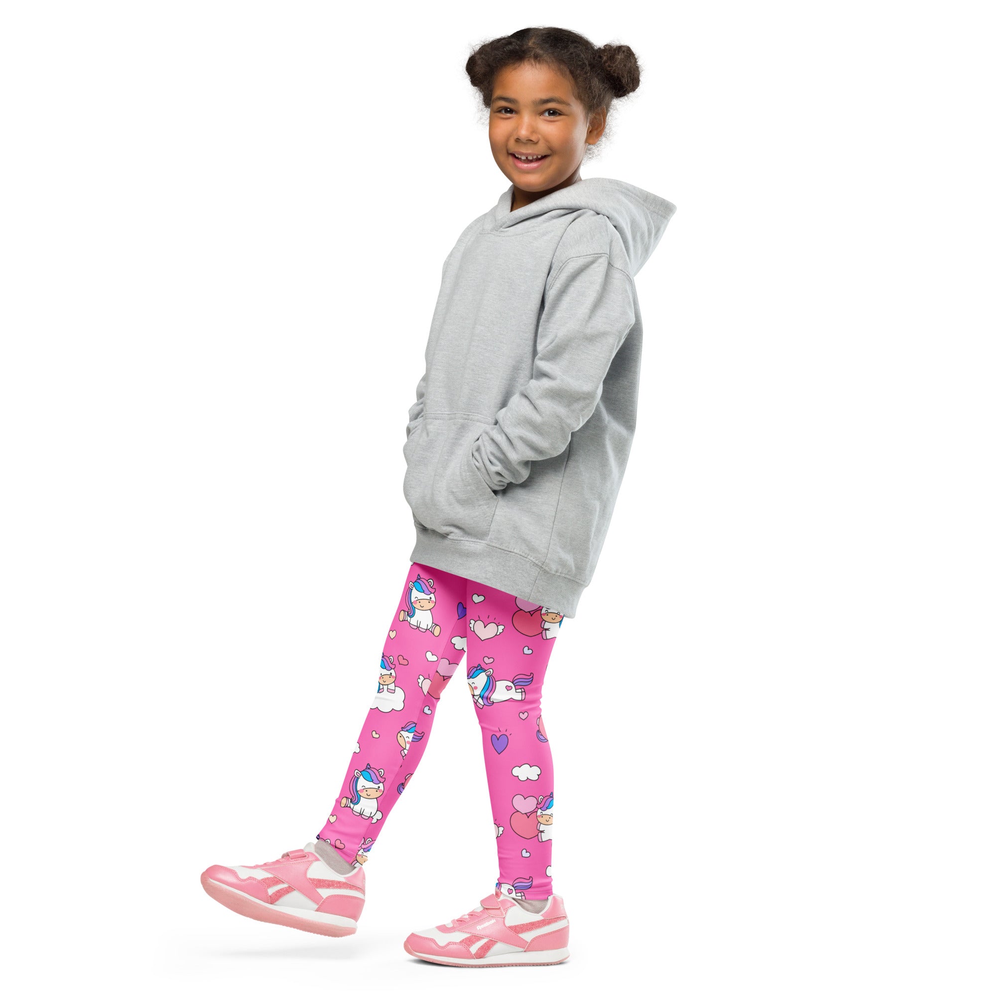 A child wearing girls unicorn hearts buttery soft bright pink leggings with cartoon unicorns hearts and clouds