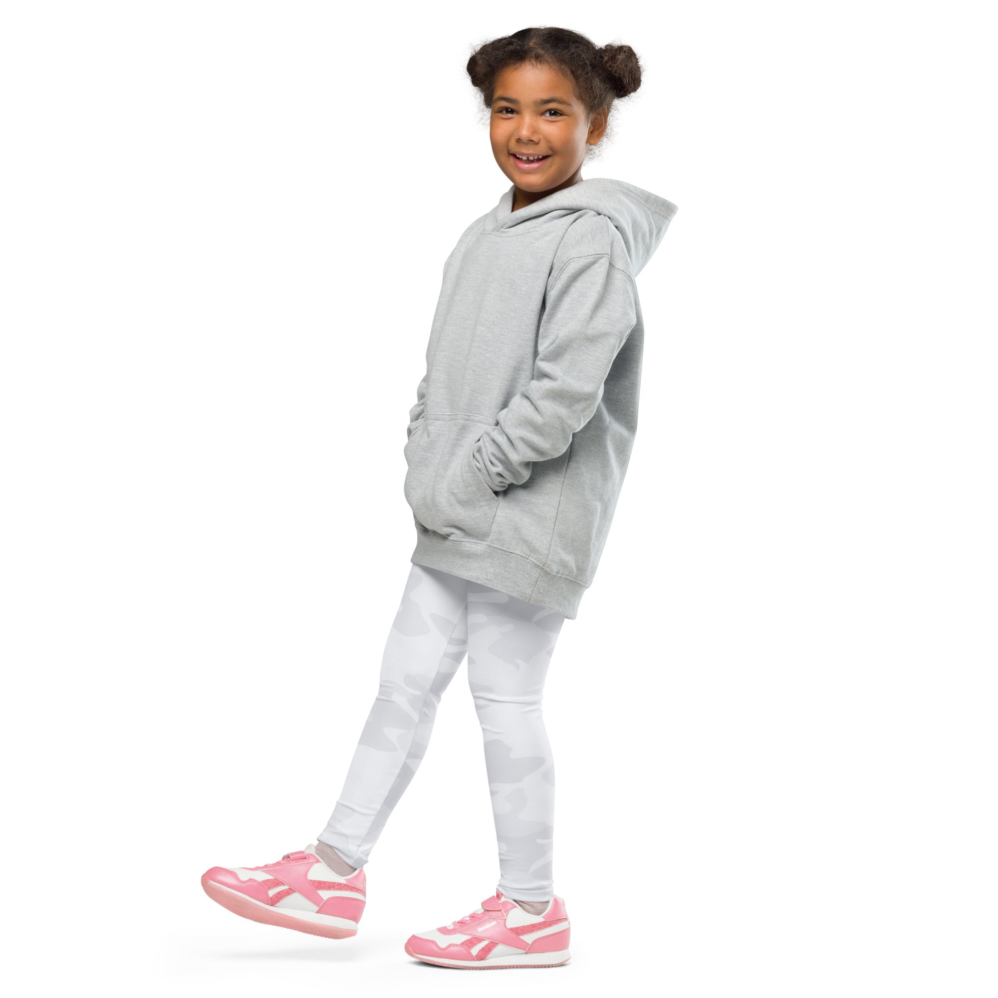 A child wearing kids white camouflage buttery soft leggings paired with a gray hooded sweatshirt and pink sneakers
