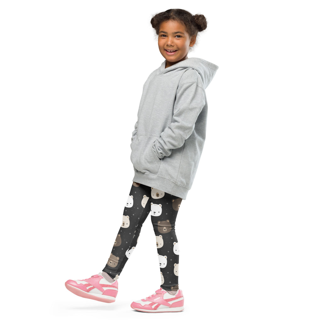 A child wearing girls bear face buttery soft leggings with dark patterned bear faces and a light gray hooded sweatshirt