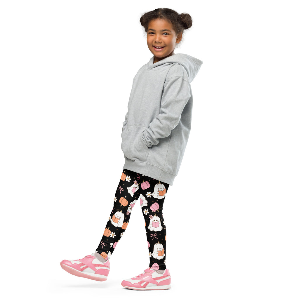 Girls reading ghosts buttery soft leggings in black with white ghost pumpkin and pink bow pattern worn with gray hoodie