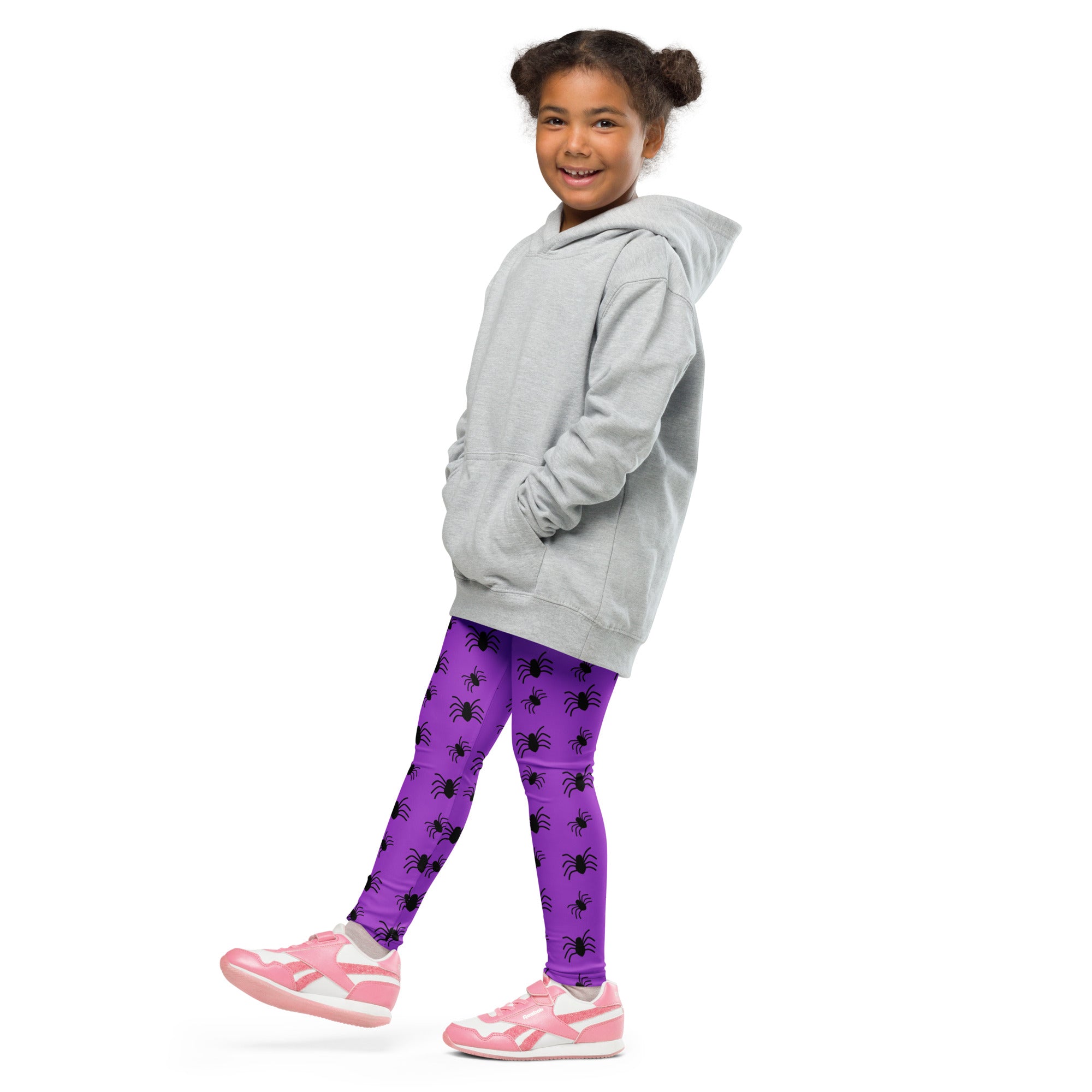 A child wearing kids purple spider halloween buttery soft leggings and a gray hooded sweatshirt