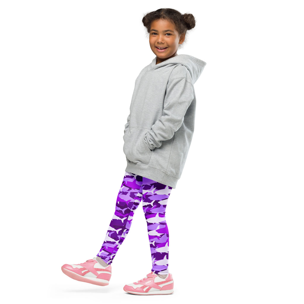 Girl wearing a gray hooded sweatshirt with front pockets and drawstring hood paired with purple shark buttery soft leggings