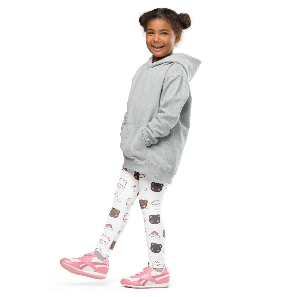 A young girl wearing girls kawaii bear rainbow buttery soft leggings in white with cute bear faces and a gray hoodie