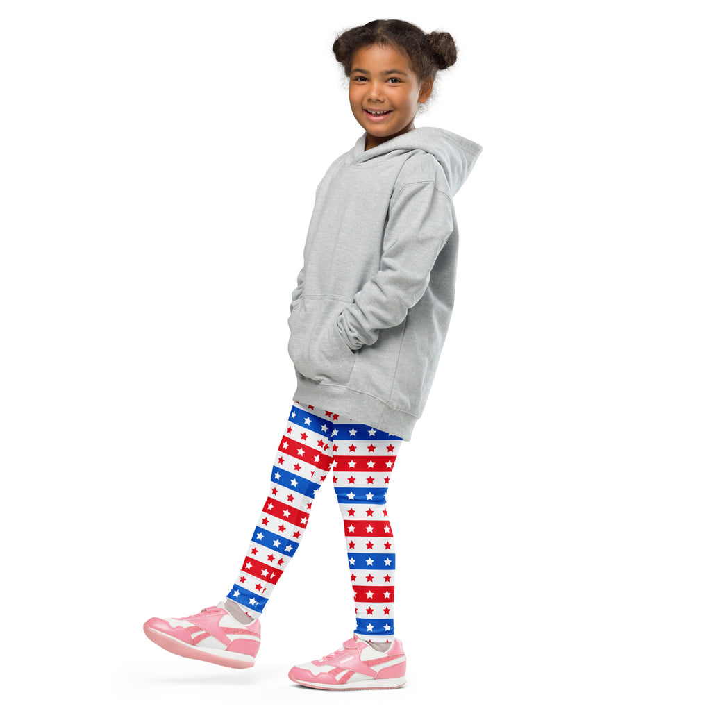 Child wearing a gray hooded sweatshirt with front pockets and drawstring hood paired with stars and stripes leggings