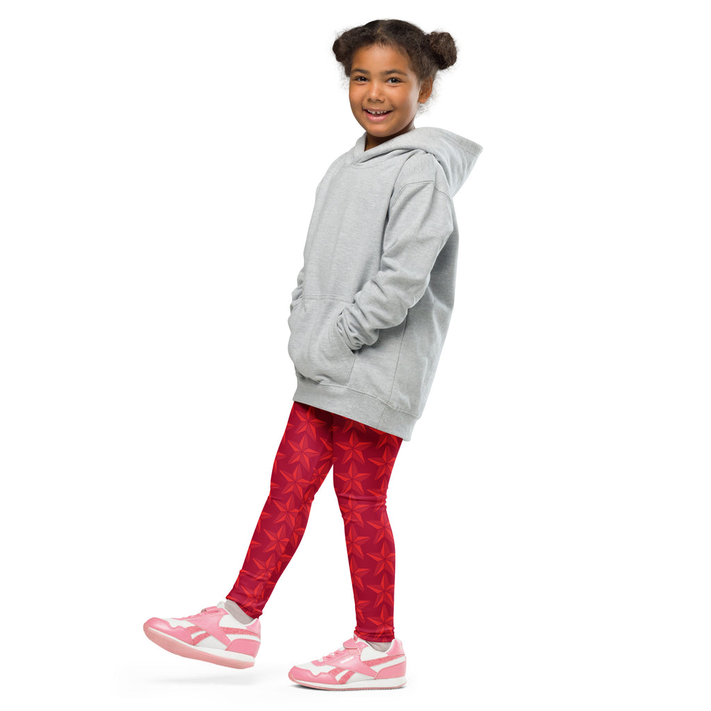 A young girl wearing girls christmas red star buttery soft leggings with vibrant red star pattern and a light gray hoodie