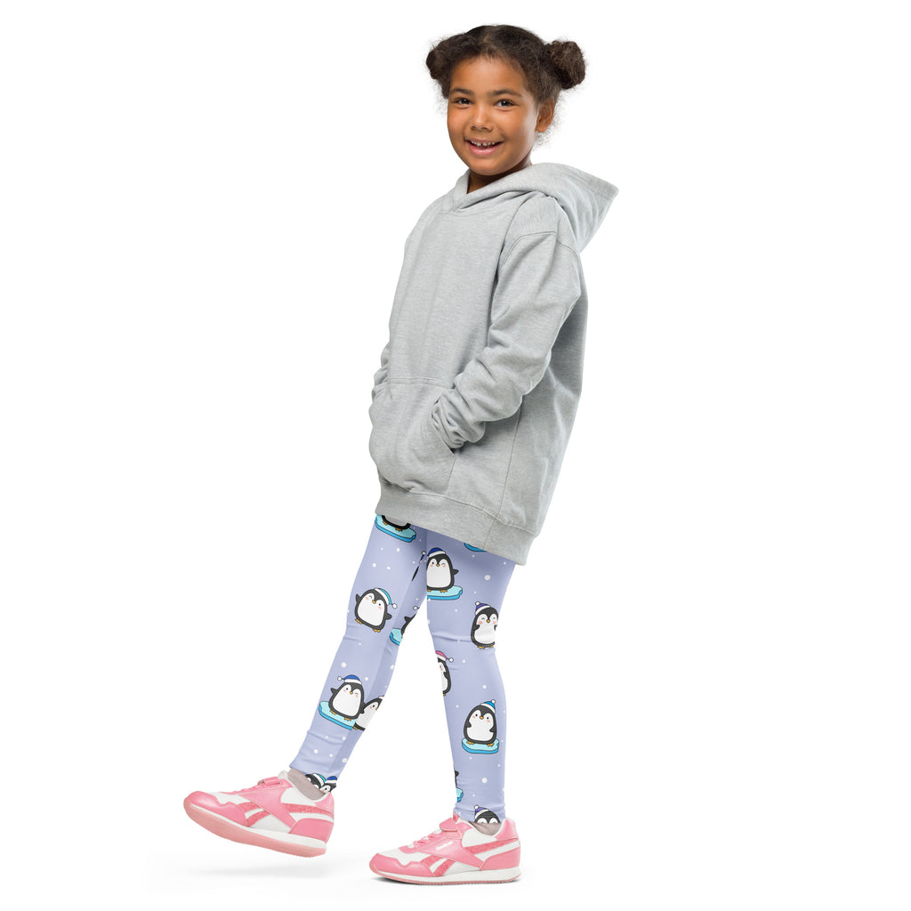 A child wearing girls winter penguin Christmas buttery soft lavender leggings with black and white prints and pink shoes