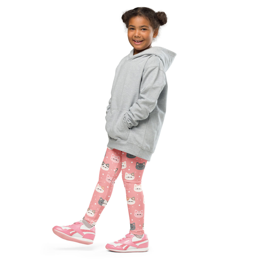 A young girl wearing girls cute pink cat faces buttery soft leggings and a light gray hooded sweatshirt