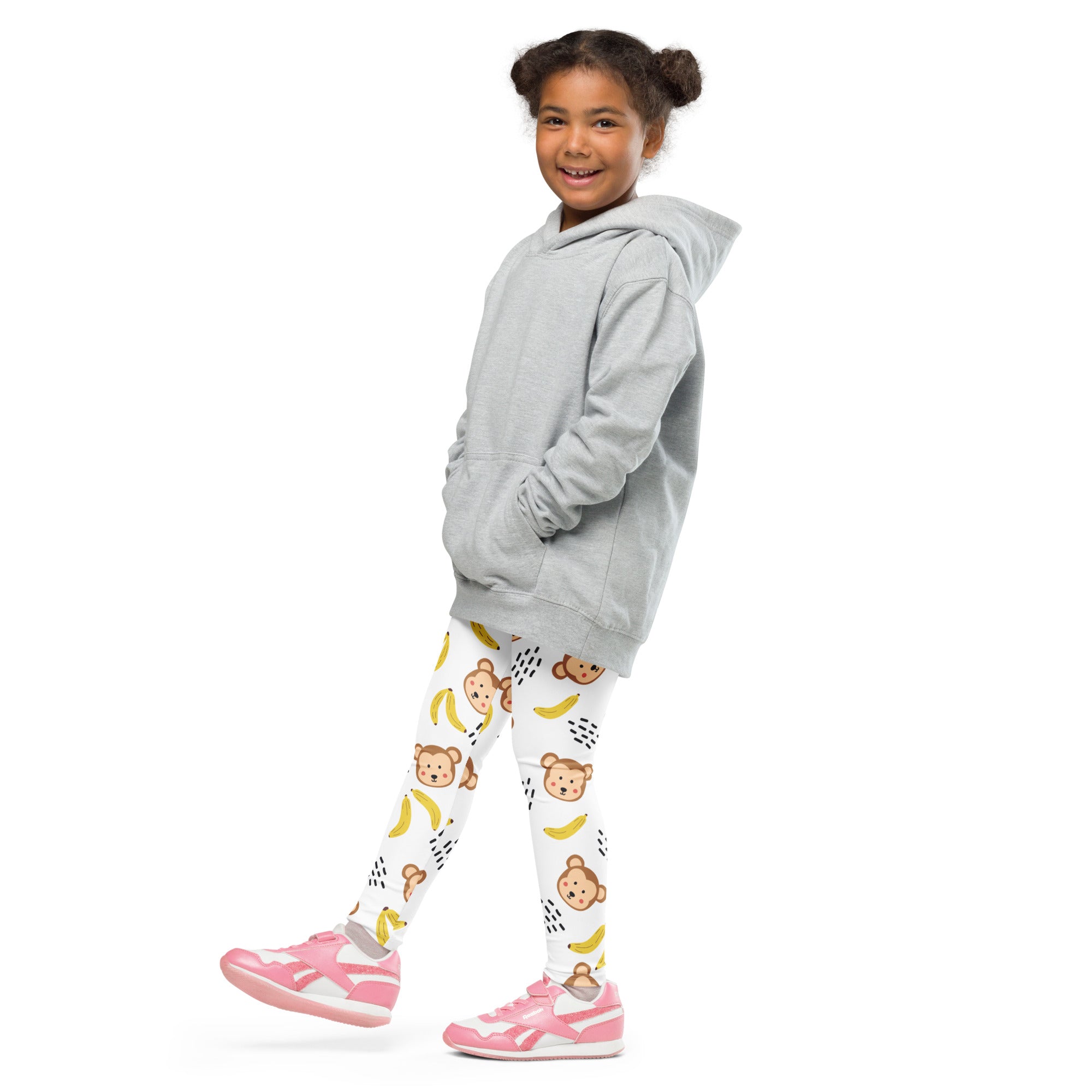 Kids monkey and banana buttery soft white leggings with playful prints worn with a gray relaxed fit hooded sweatshirt