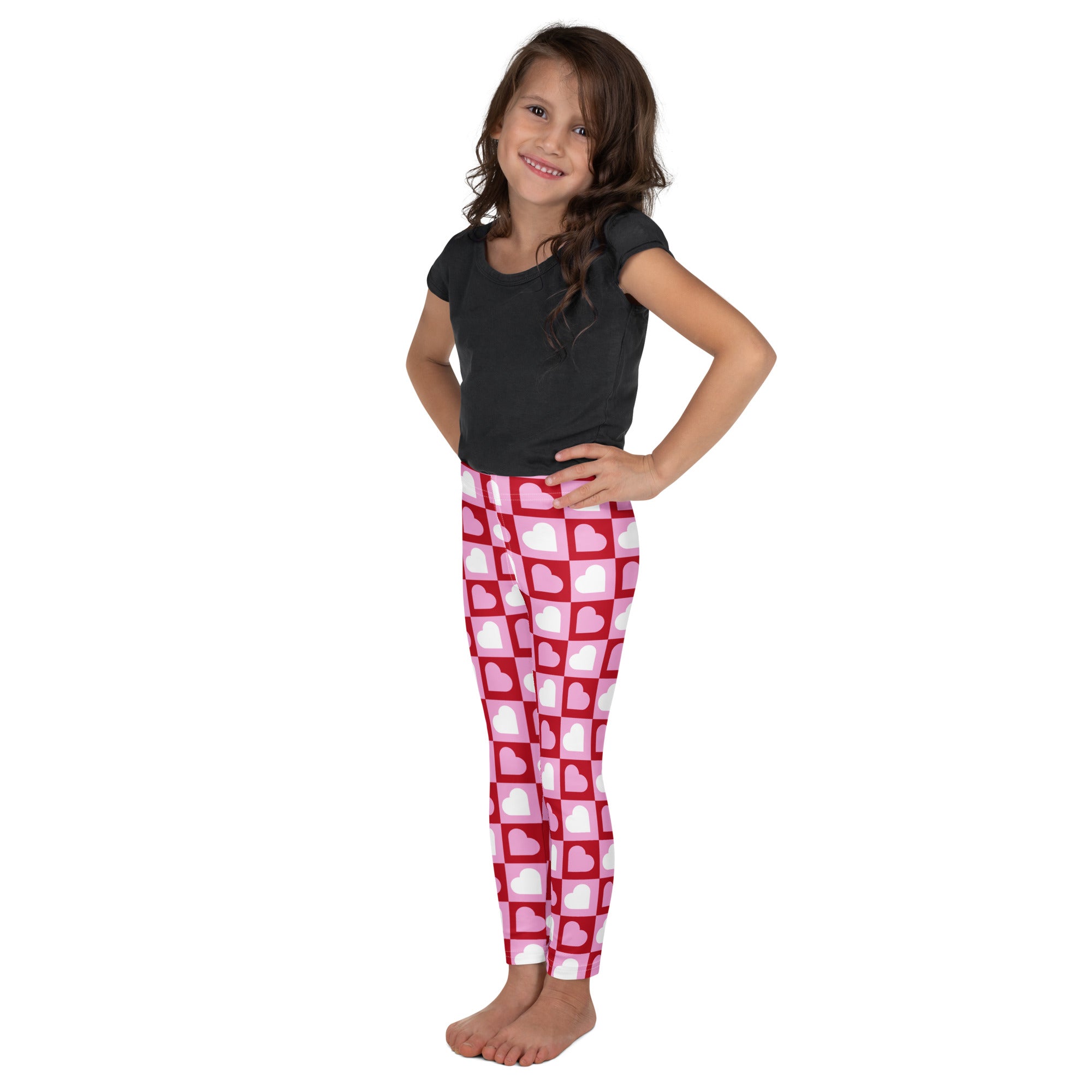 Girls pink buttery soft leggings with white heart pattern and pink checkered grid design for comfortable wear