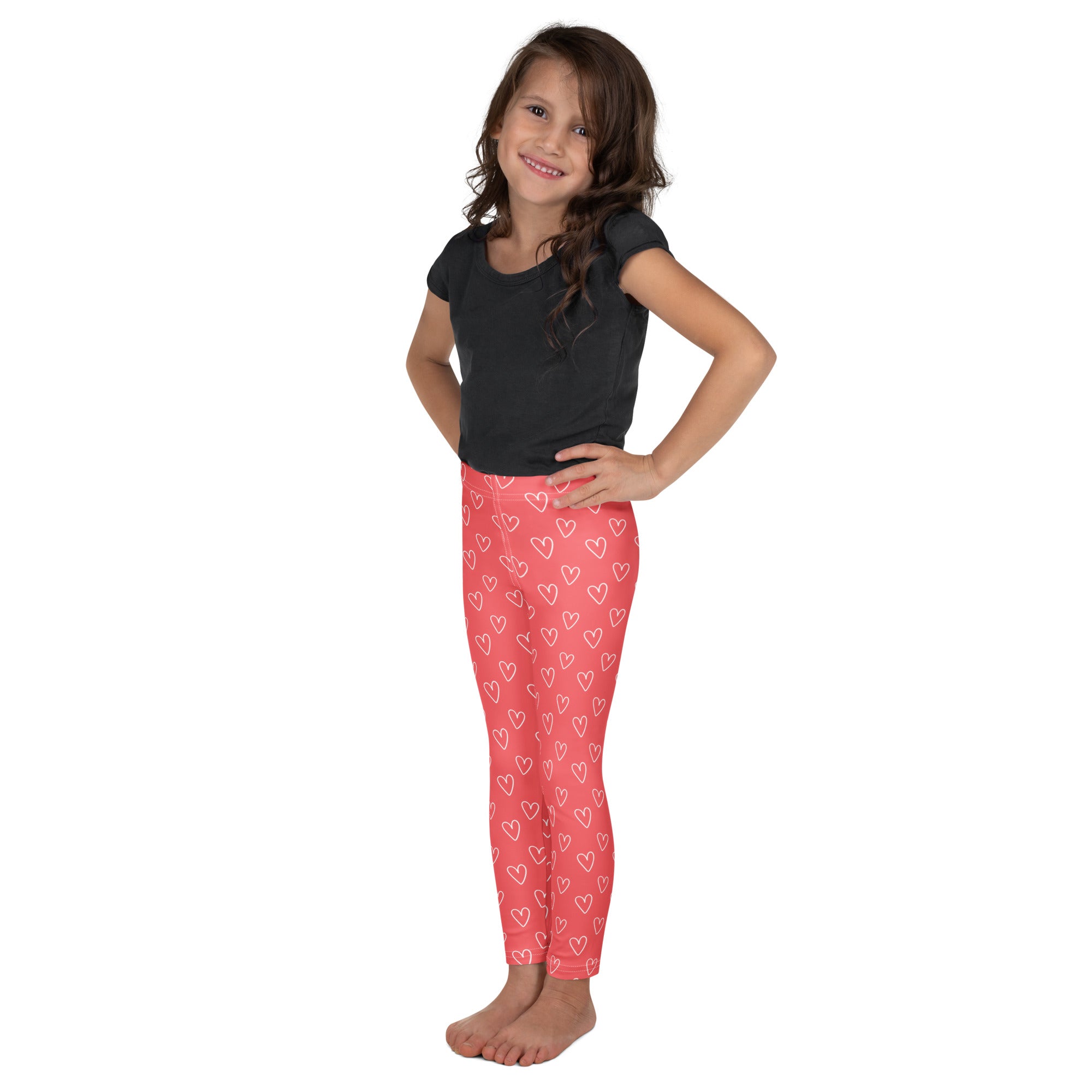 Girls pink heart outline buttery soft leggings featuring white heart patterns for comfortable everyday wear