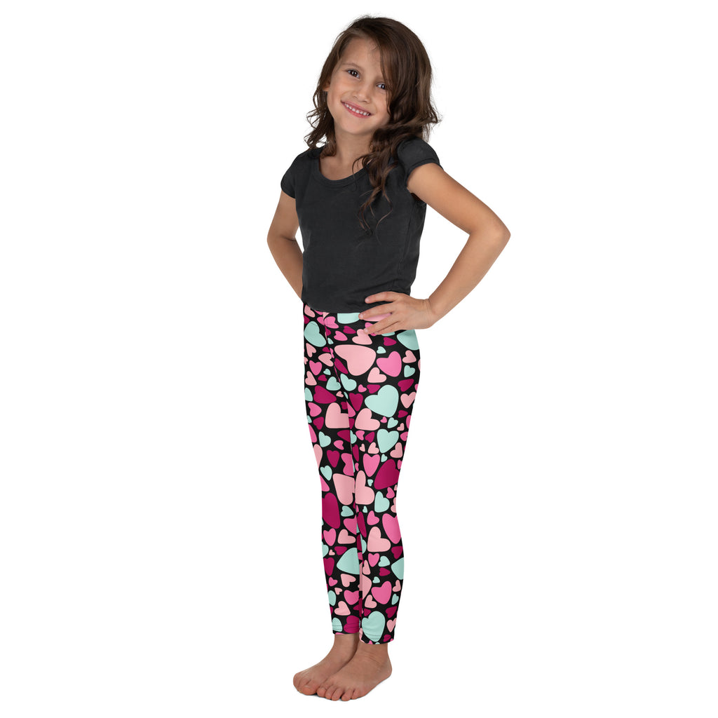Girls multicolor heart buttery soft leggings in pink and mint worn by a young girl showing front side