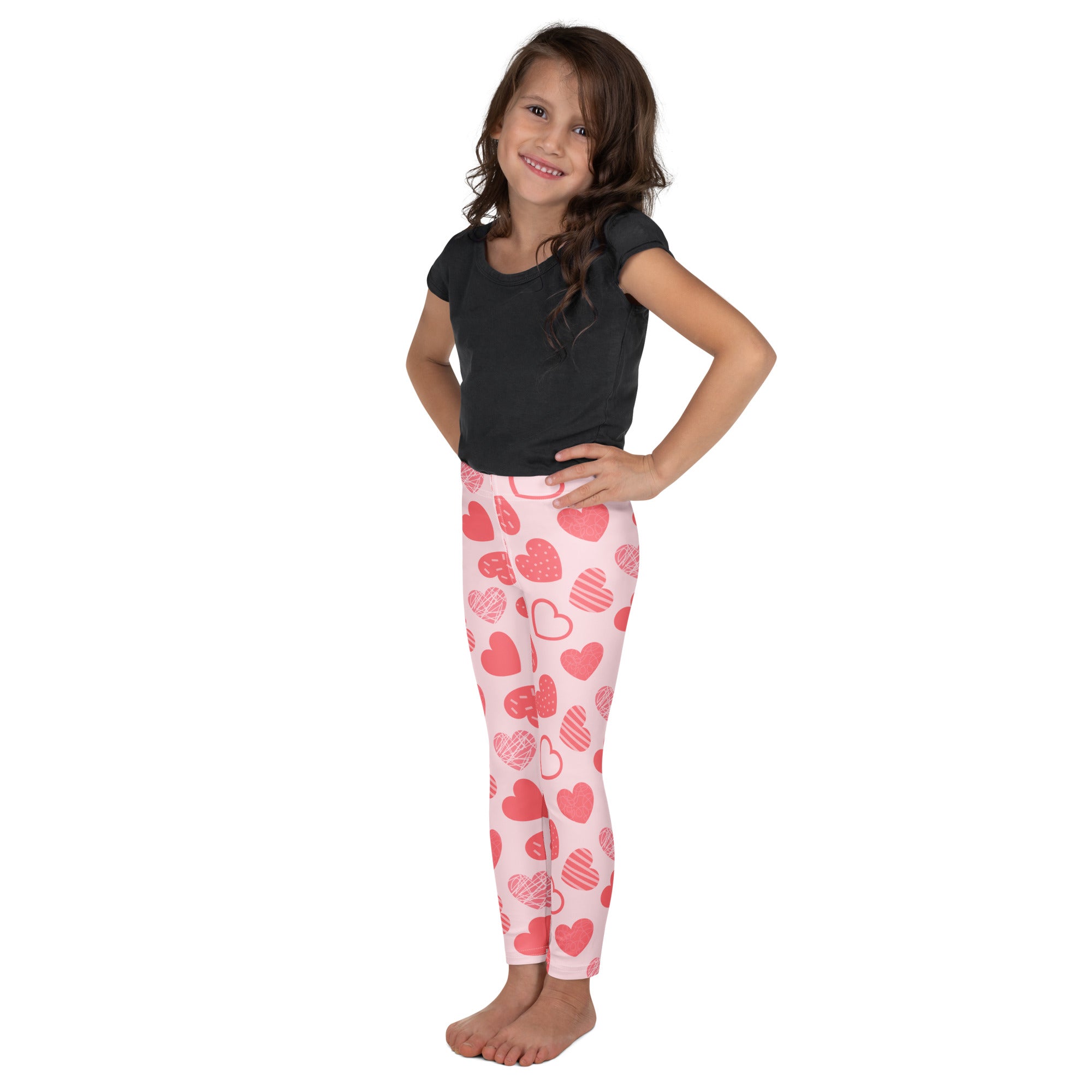 Girls pink buttery soft leggings with a playful red and pink heart pattern for comfortable everyday wear